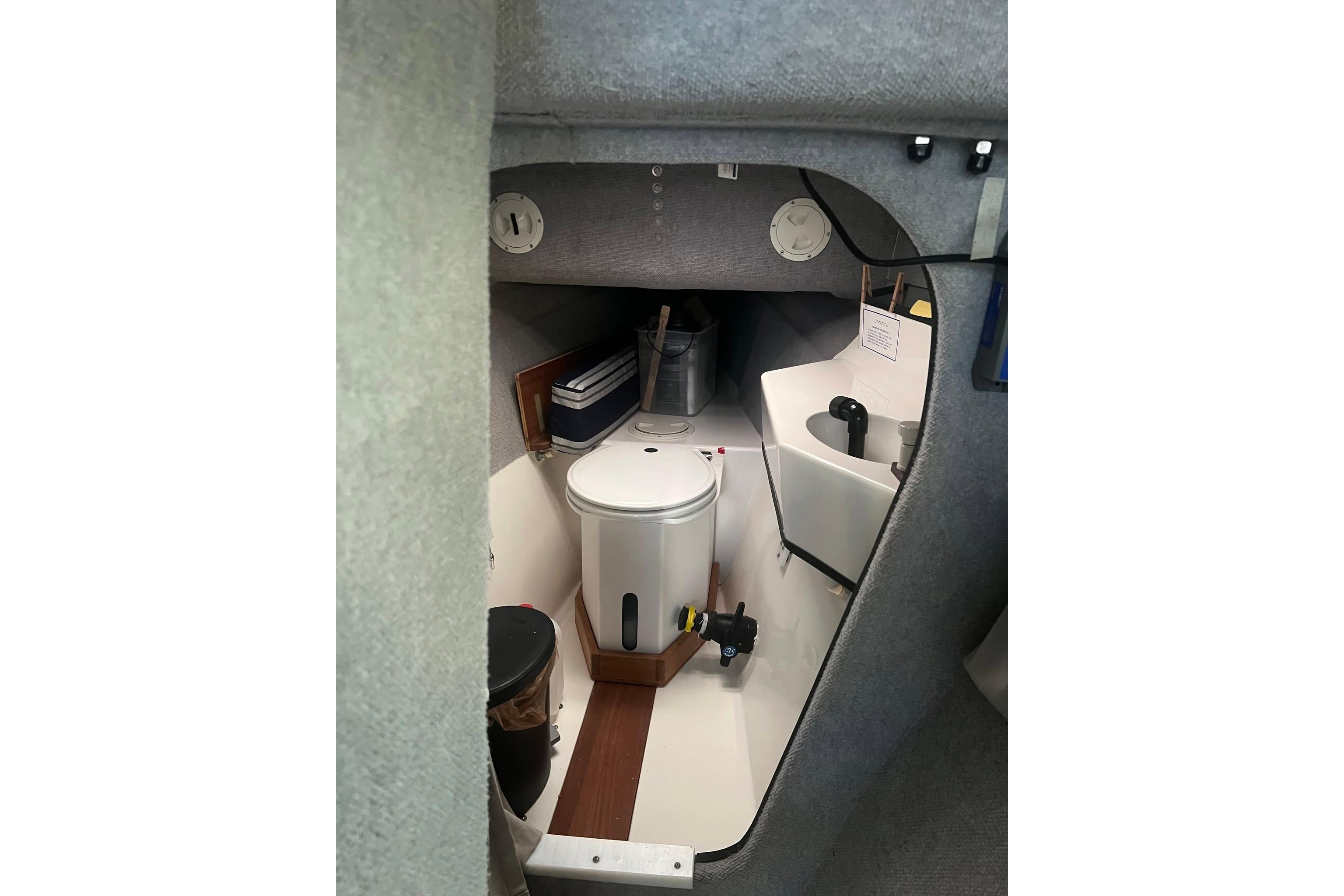 Interior of 1993 Corsair F-27 sailboat featuring compact cabin amenities.