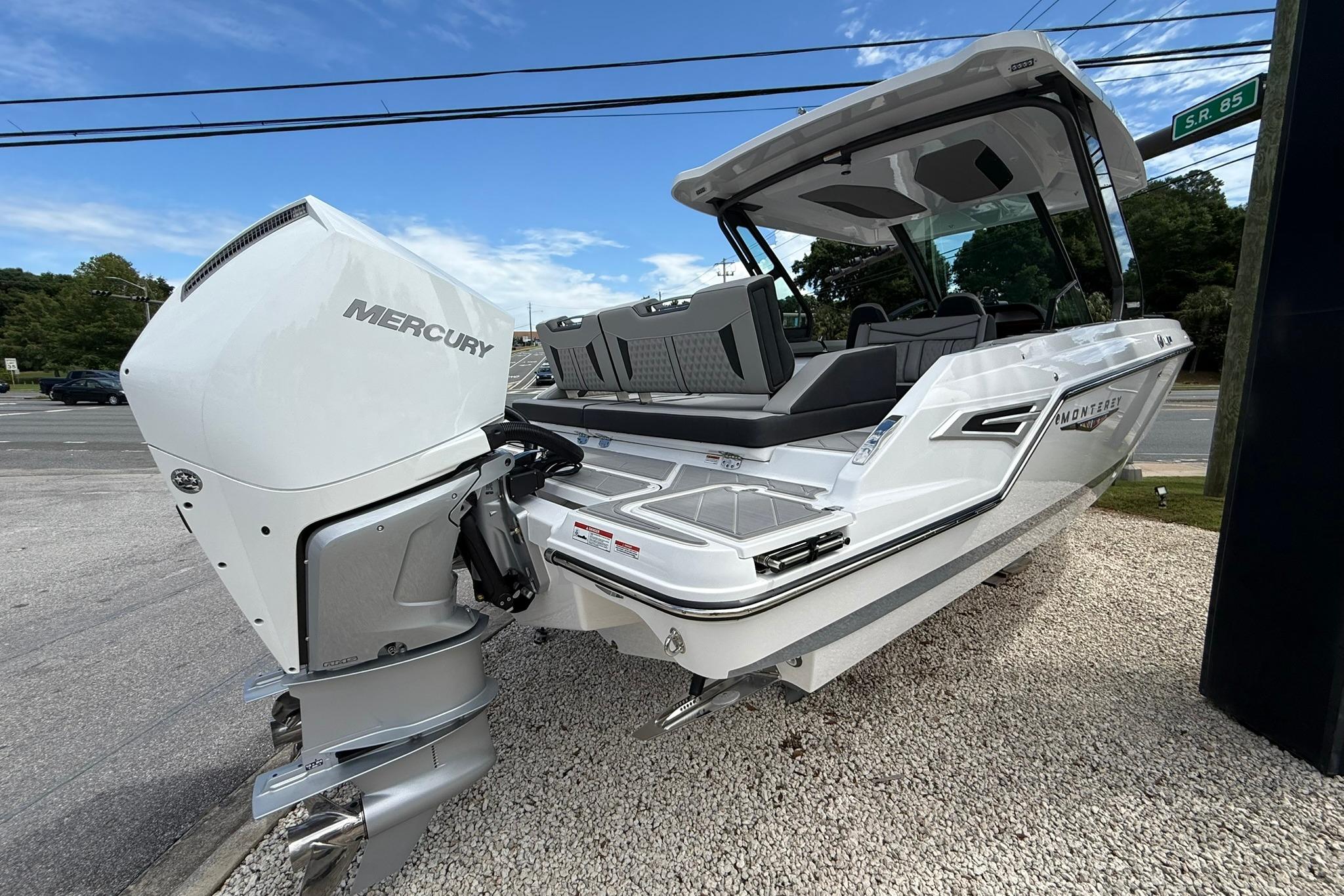 2027 Monterey Elite 30 OB boat with Mercury outboard engine, displayed outdoors.