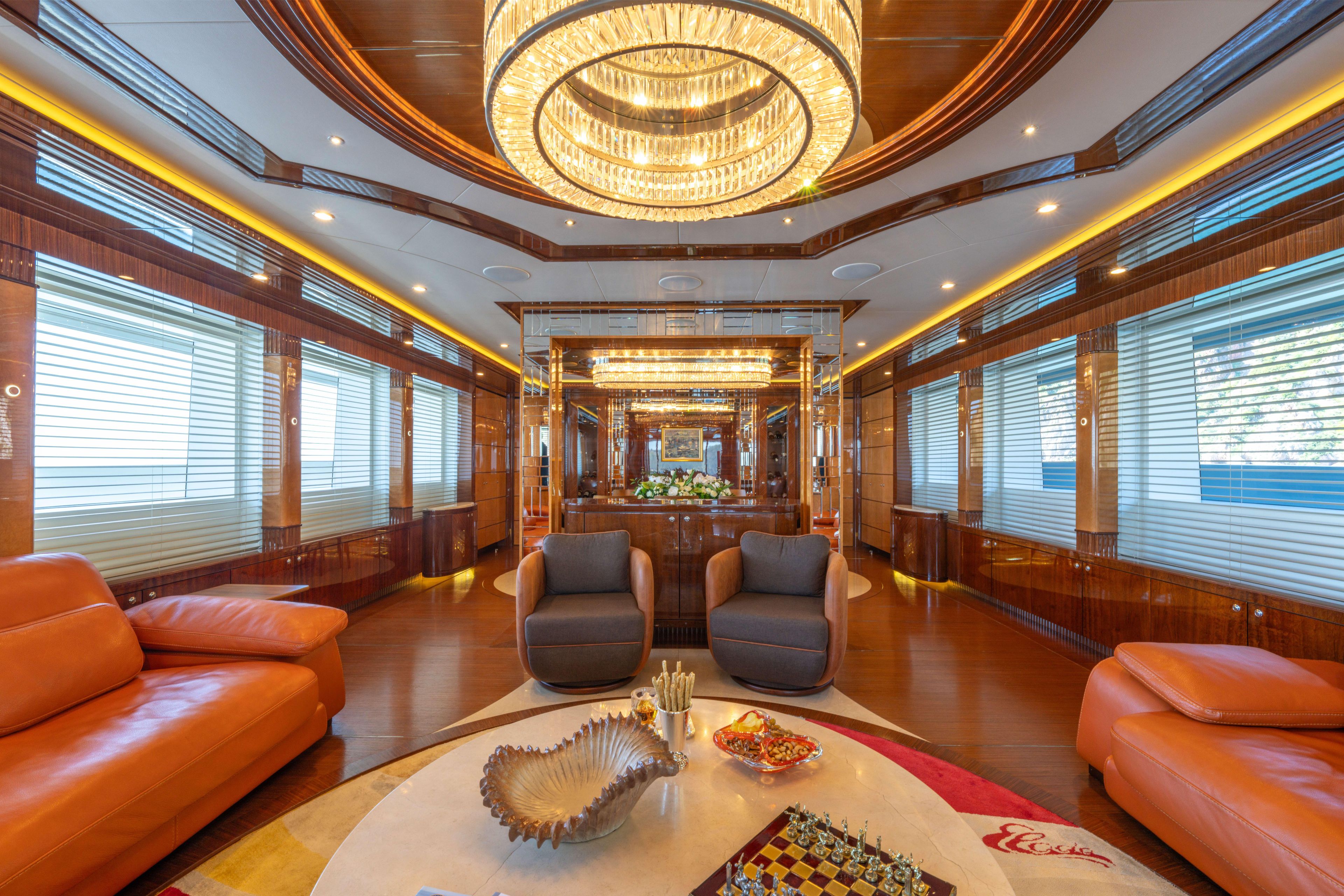 Luxurious interior of 2014 Bilgin 147 yacht with elegant furnishings and chandelier.