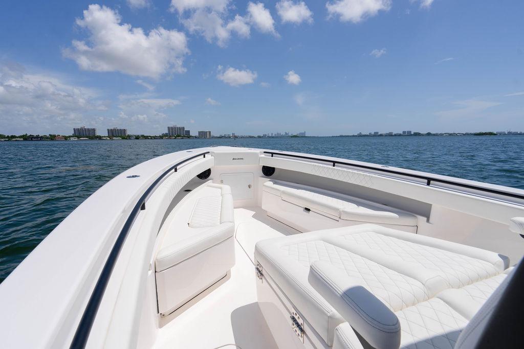 Luxurious 2027 Reef Runner 340 boat interior with white seating on open water.