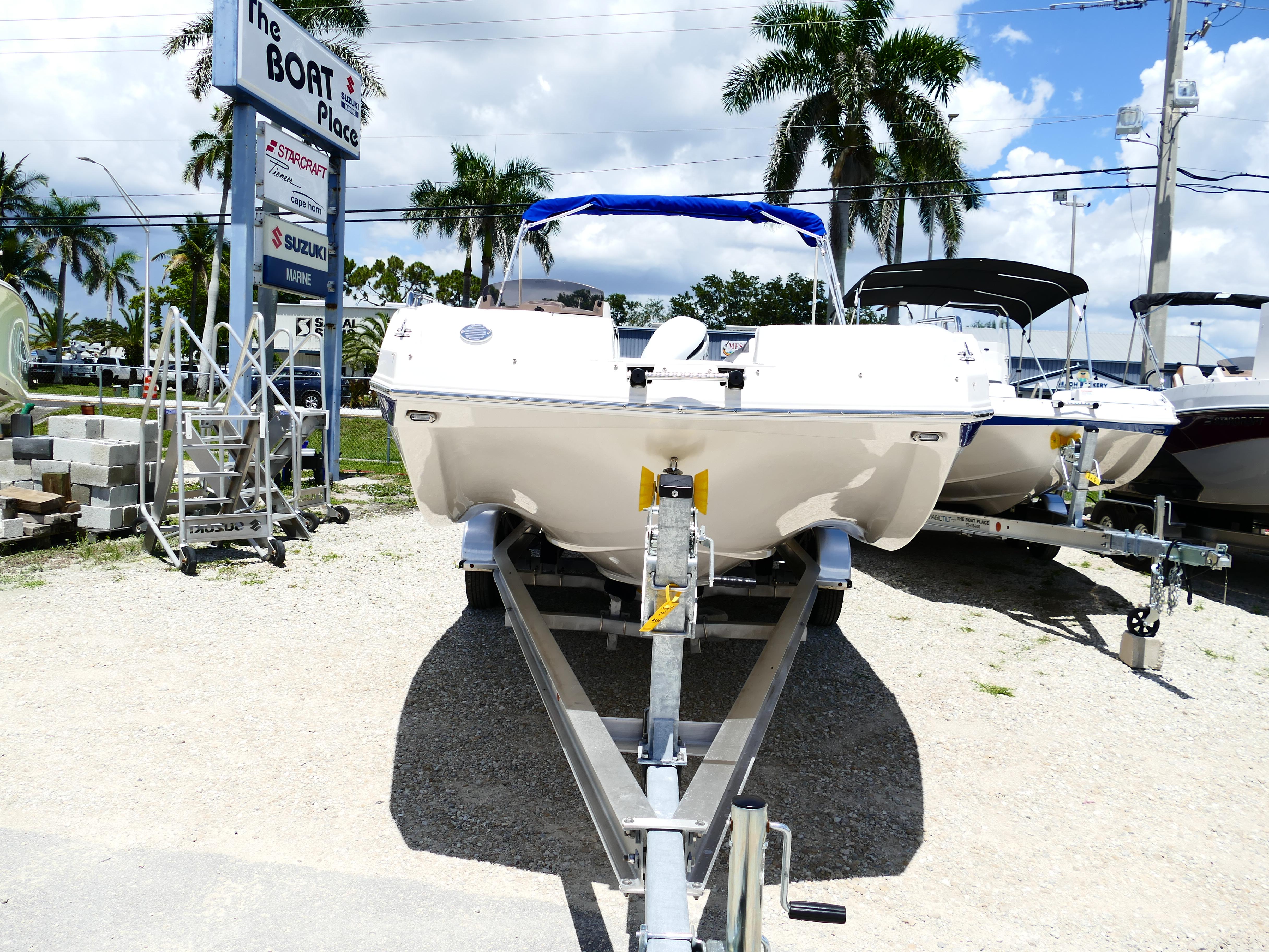2026 Starcraft SVX 231 OB DH boat on trailer at dealership, sunny day.