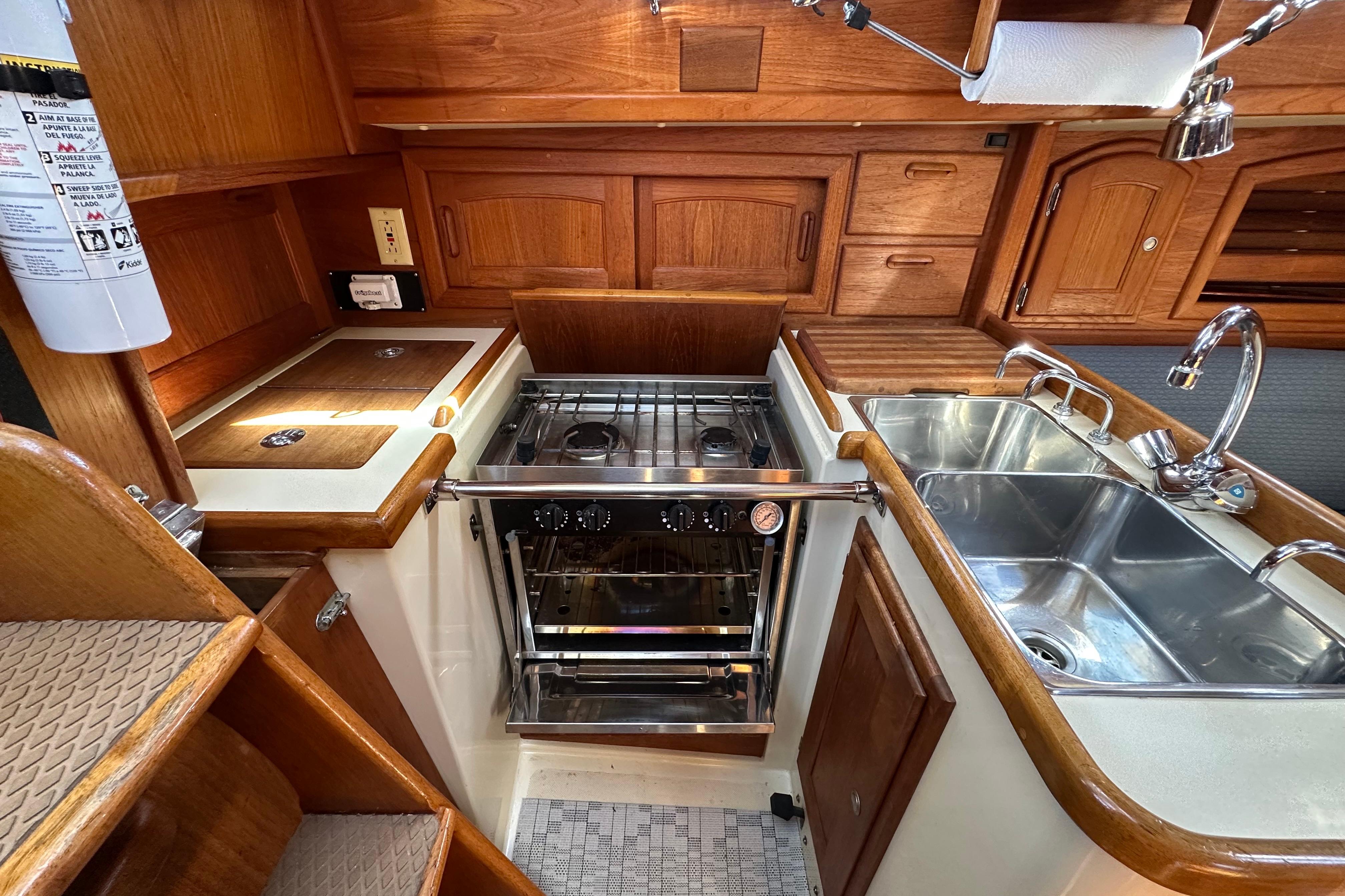 Interior of 1997 Pacific Seacraft Crealock 34 yacht kitchen with stove and sink.