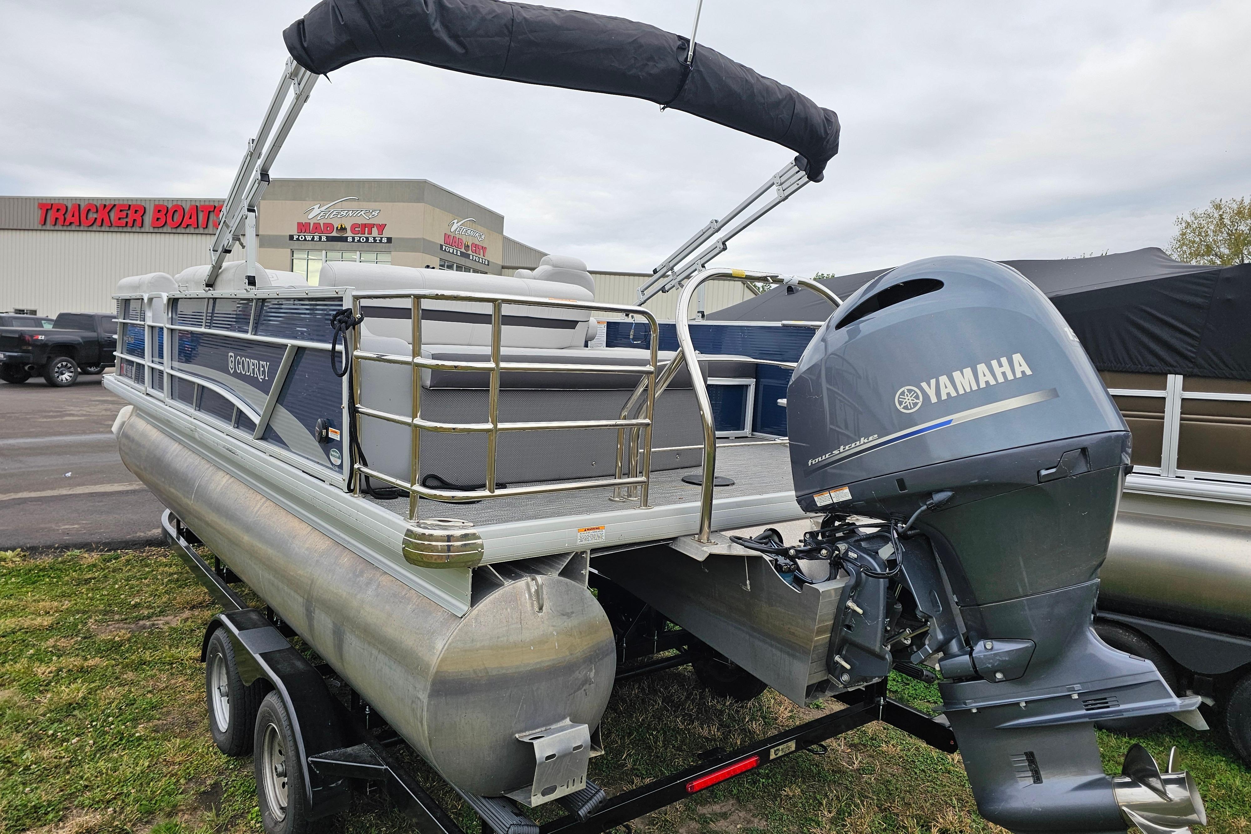 2022 Sweetwater 2286 SFL pontoon boat with Yamaha motor on trailer at dealership.