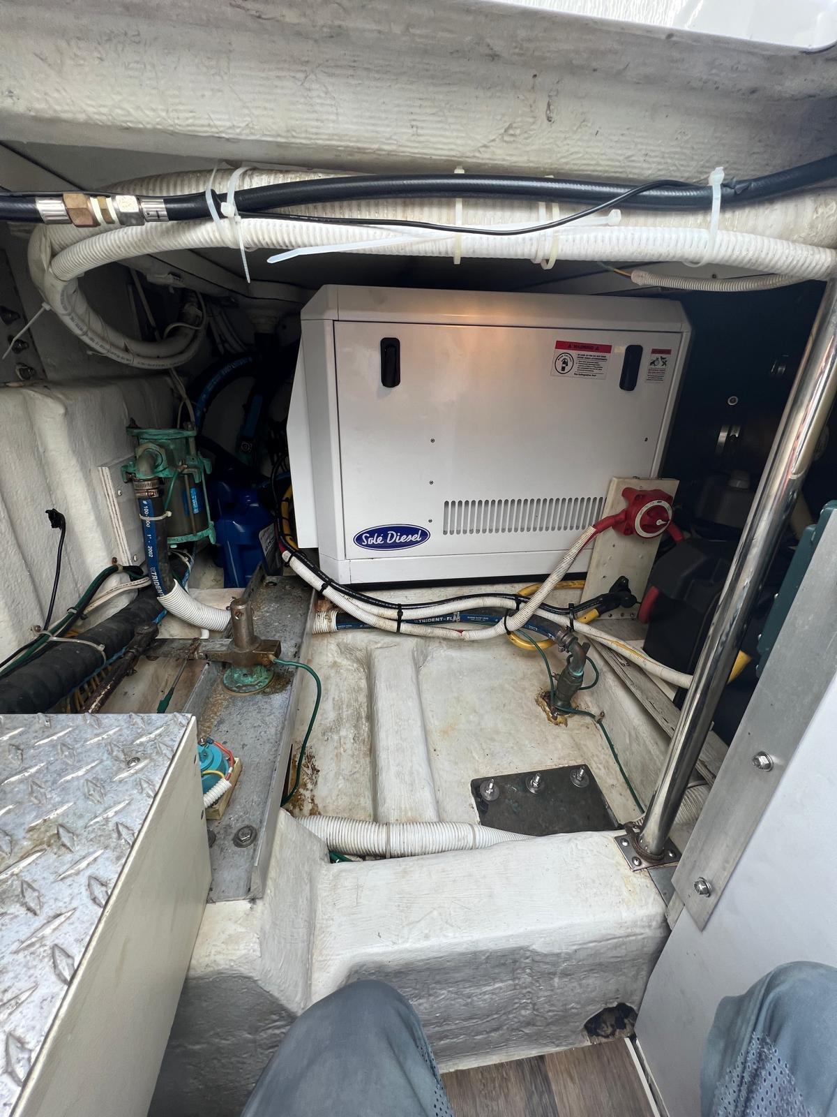 Engine room of a 2003 Carver 360 Sport Sedan, featuring a generator and wiring.
