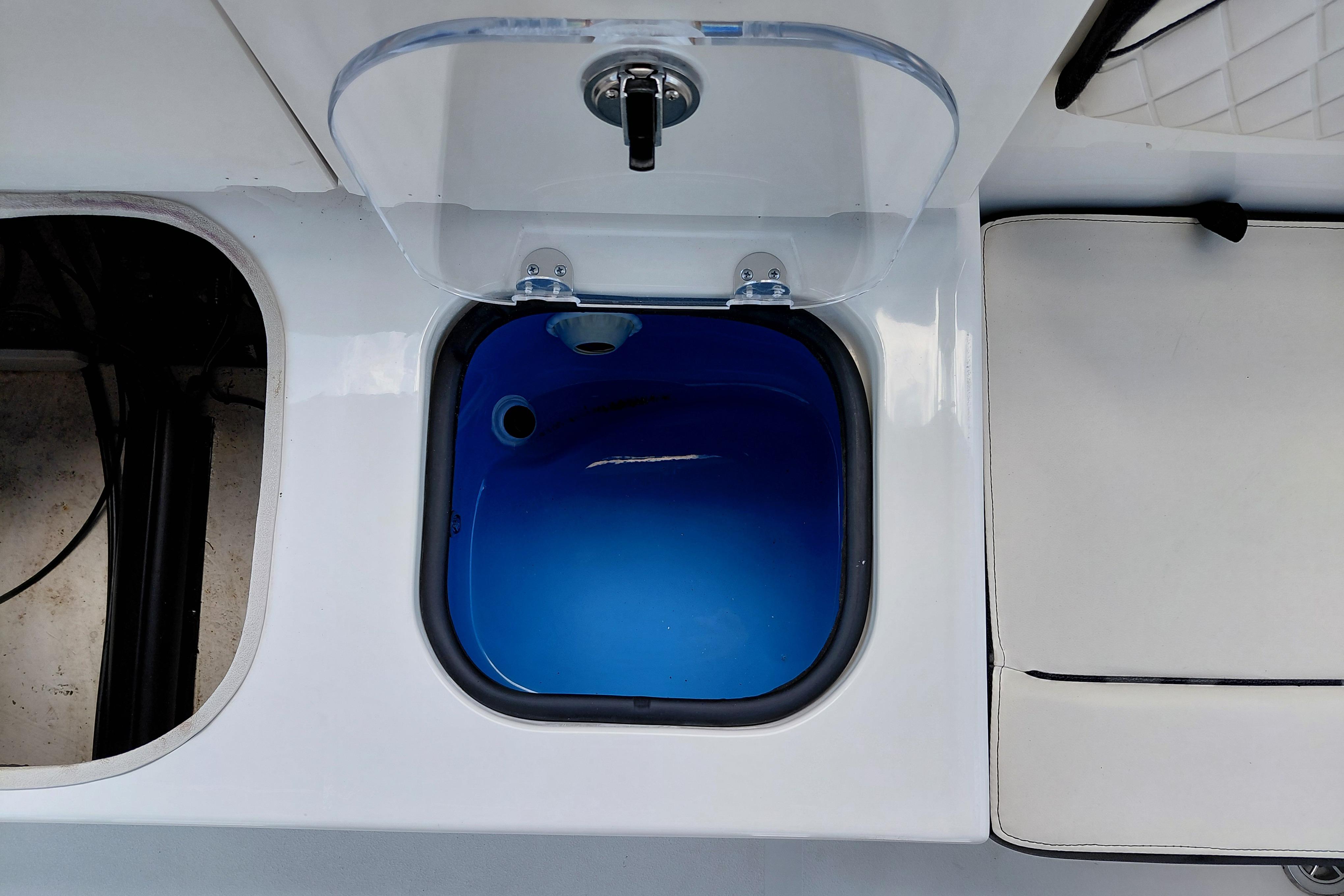 Livewell compartment on a 2023 Stingray 206 CC boat, featuring a blue interior.