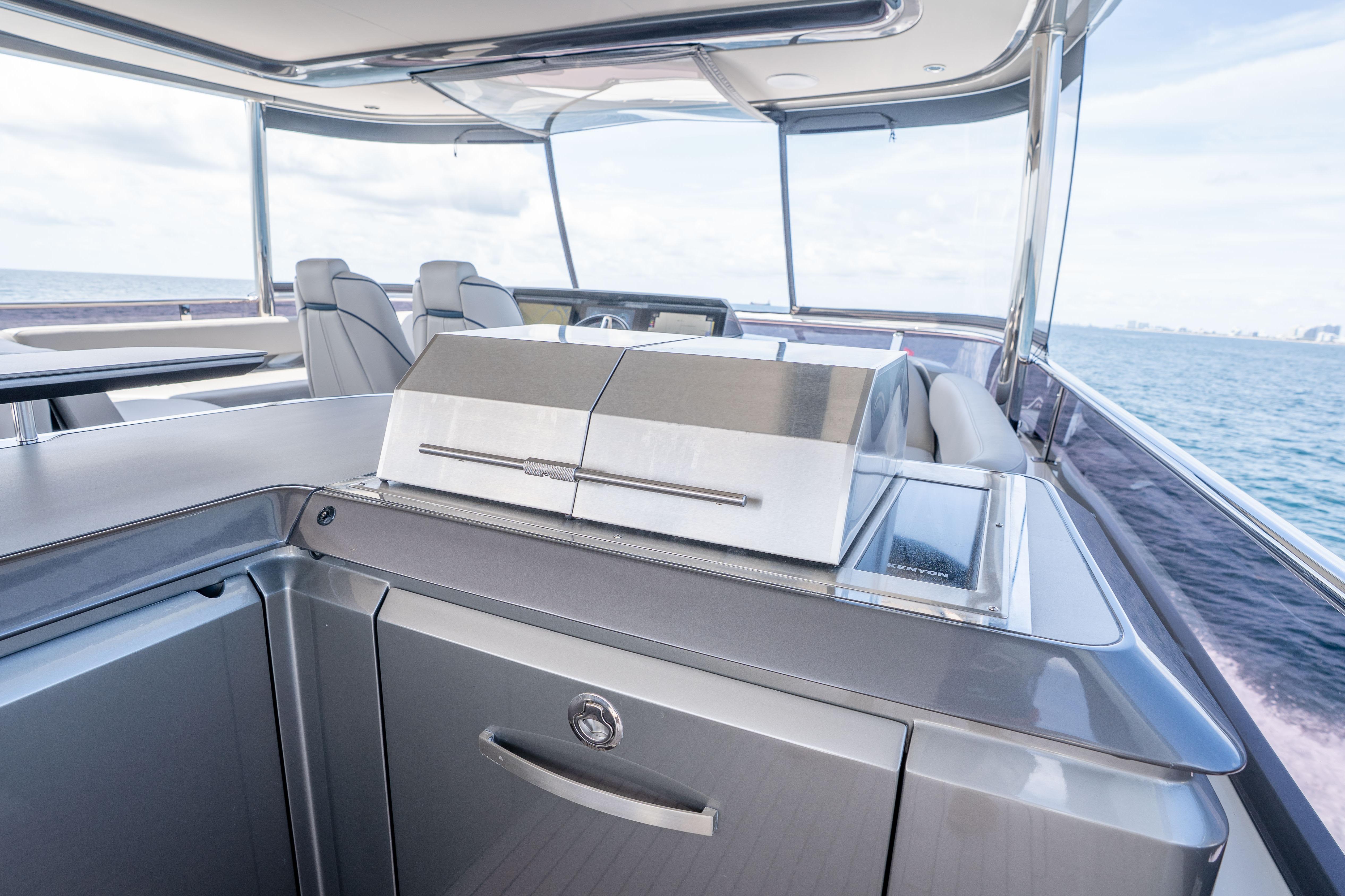 Luxurious 2020 Princess Y85 yacht deck with modern outdoor kitchen and seating area.