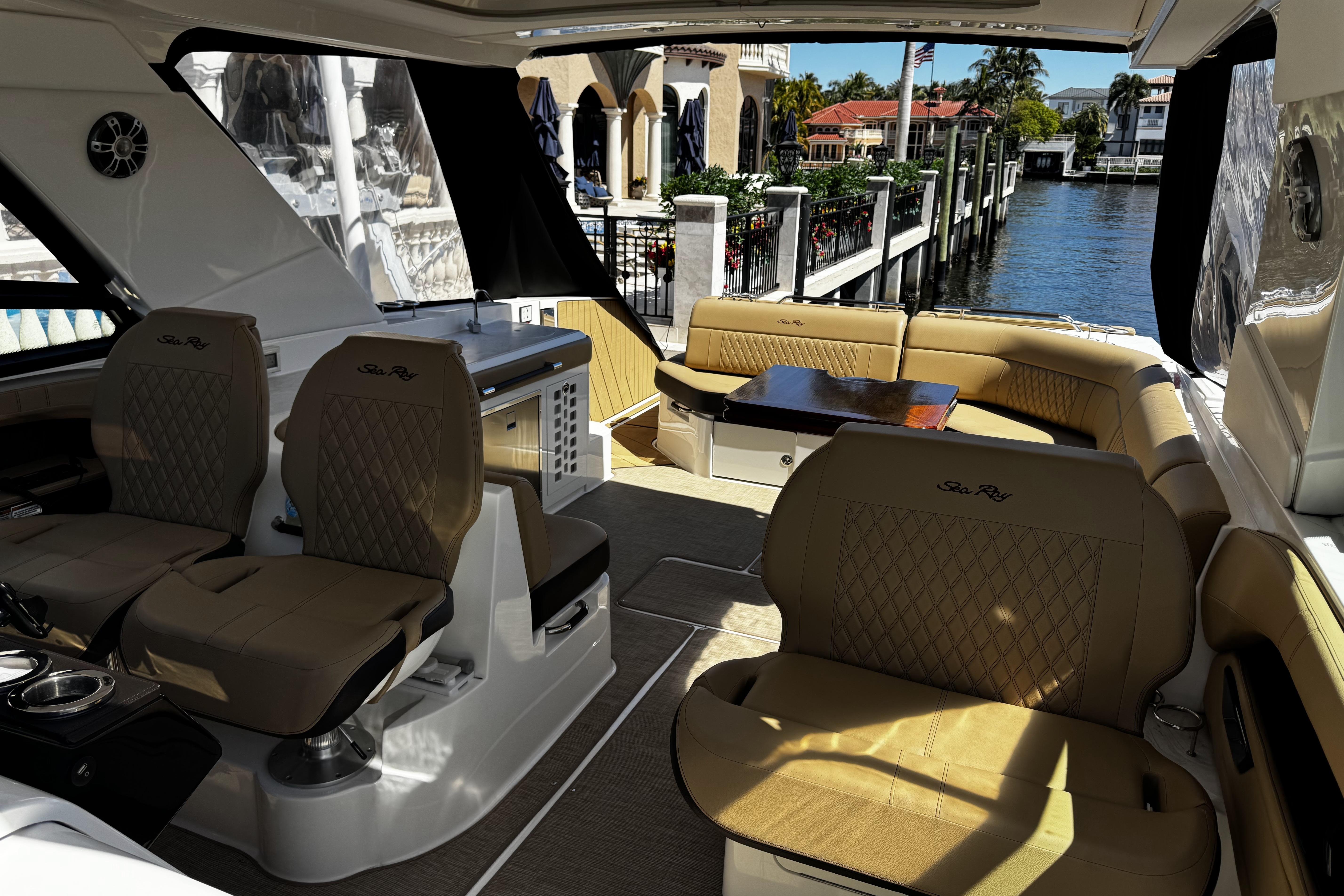 Luxurious interior of 2023 Sea Ray SLX 400 yacht with elegant seating and waterfront view.