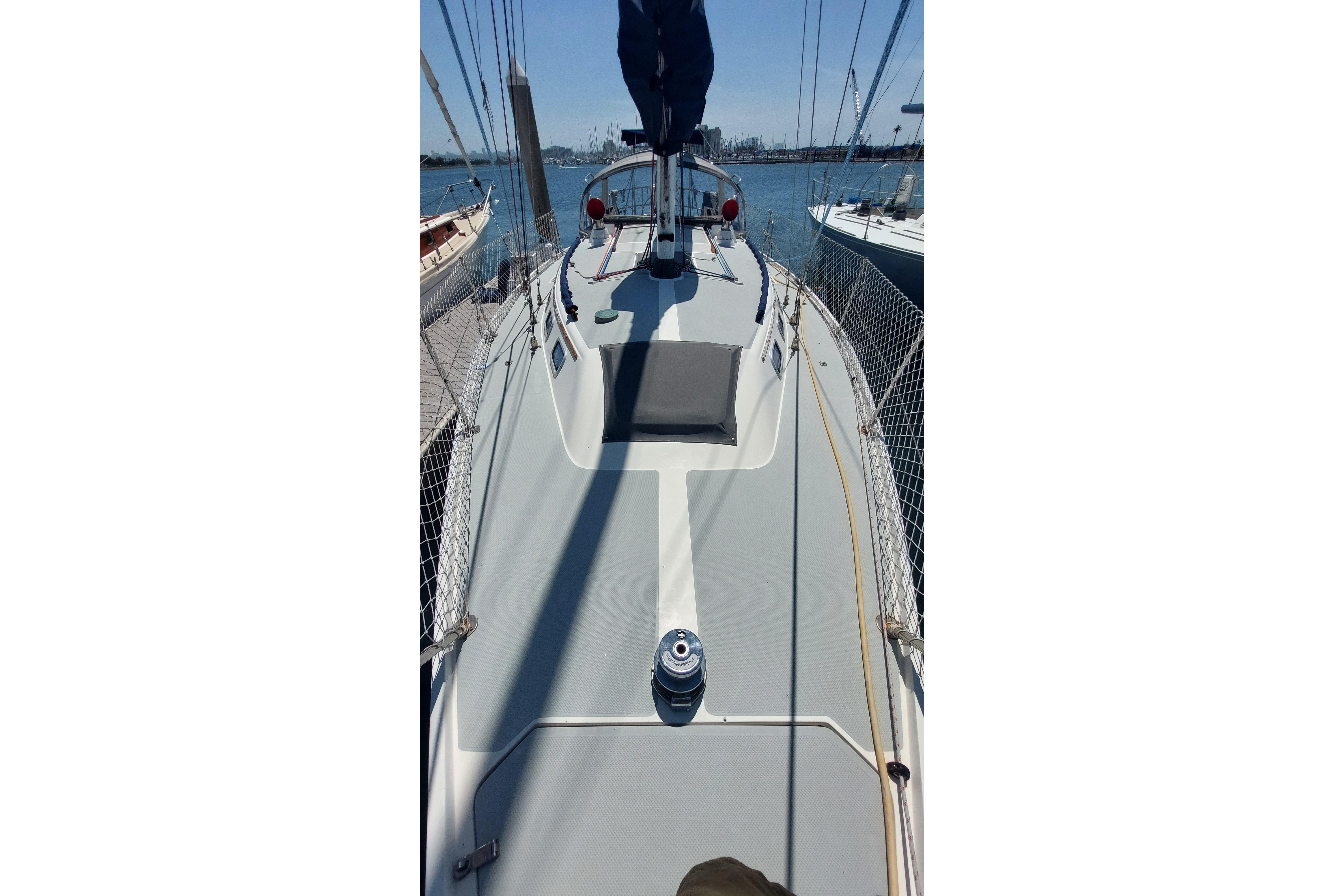 1989 Catalina 34 sailboat deck view with clear skies and calm waters.