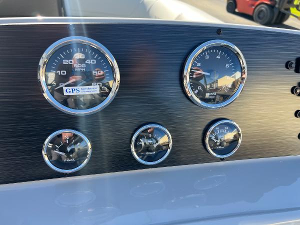 Dashboard with speed and fuel gauges.
