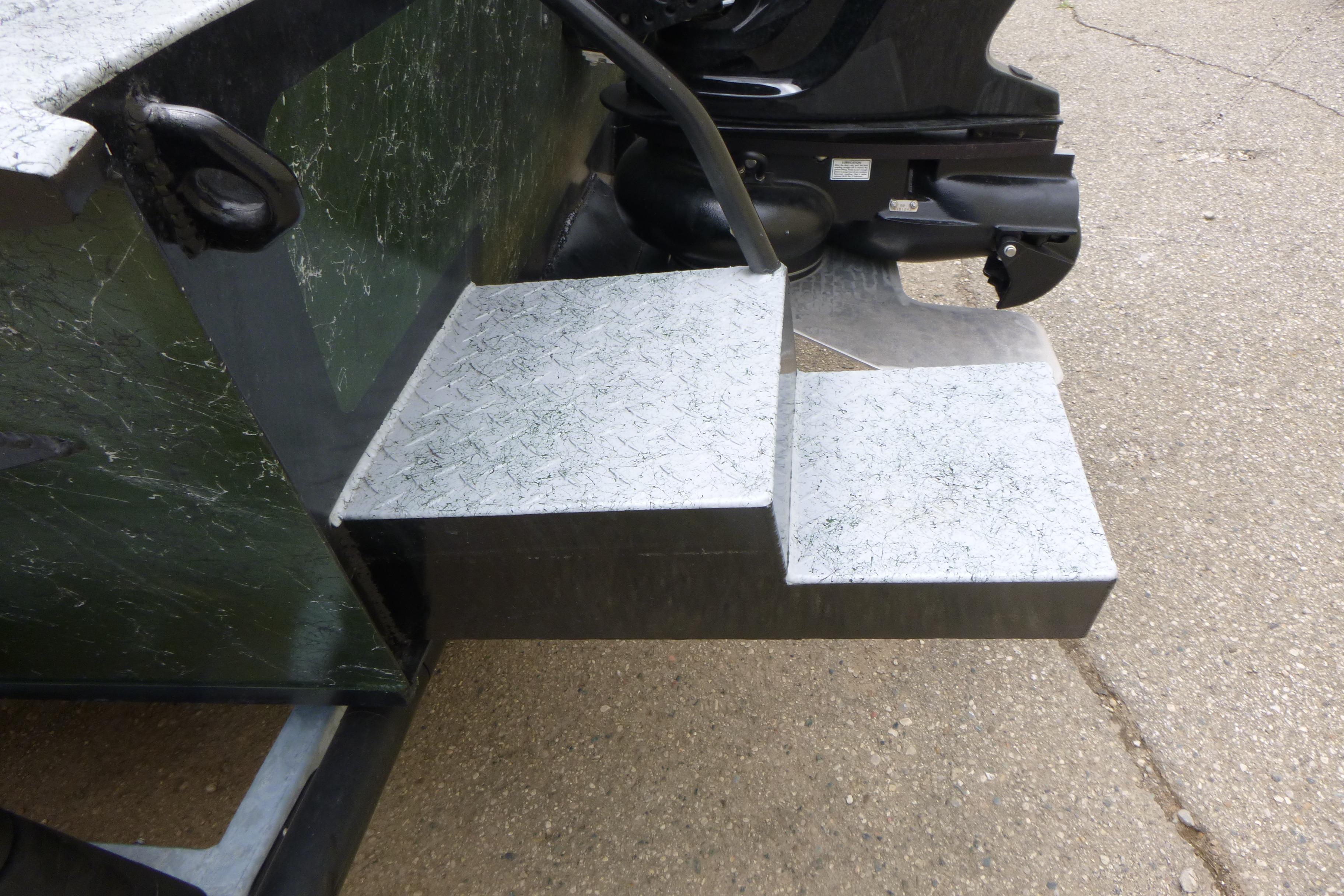 StealthCraft 16 StealthWeld 2025 boat with metal steps and motor detail.