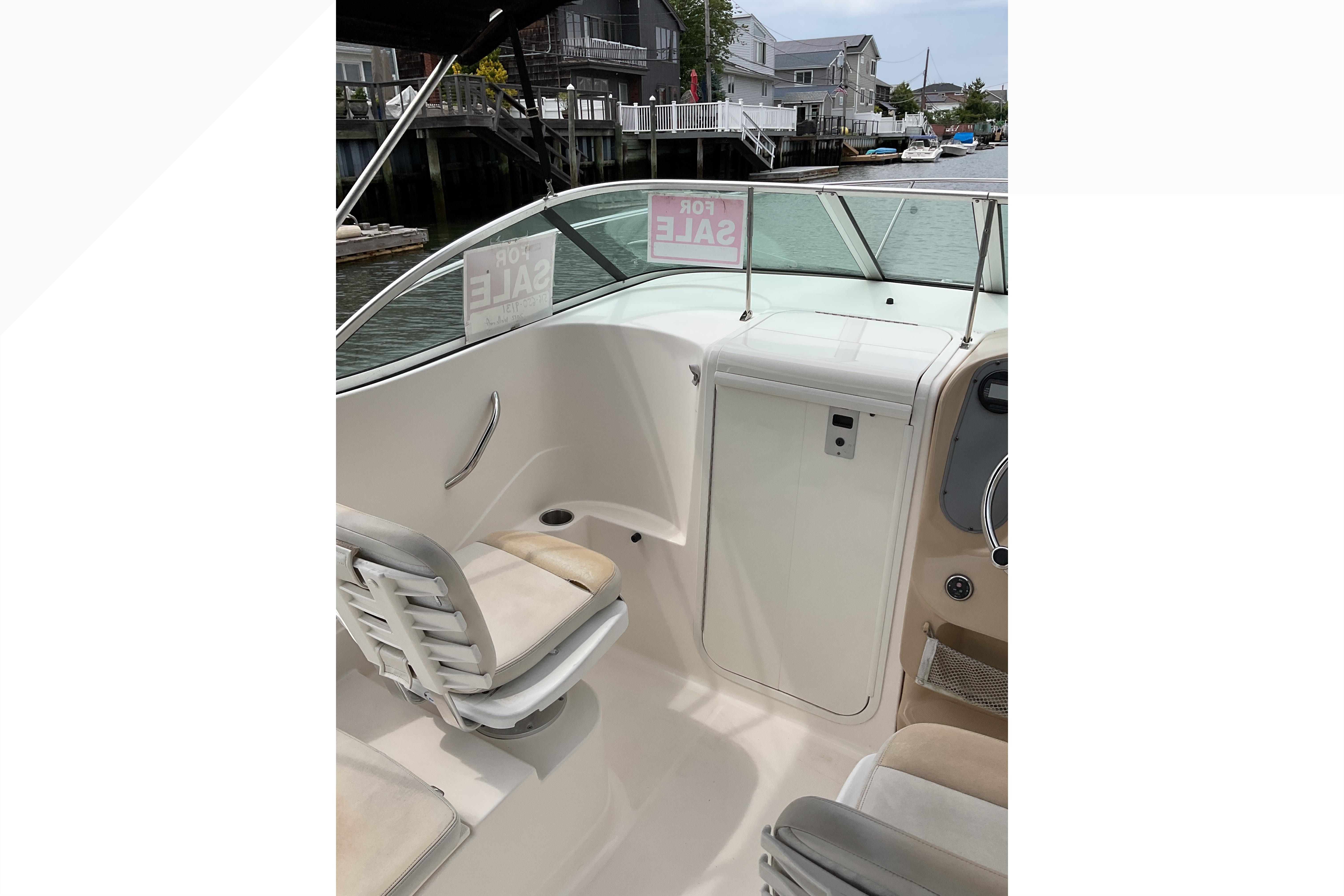 2012 Wellcraft 232 Coastal boat interior with seating, for sale sign visible.