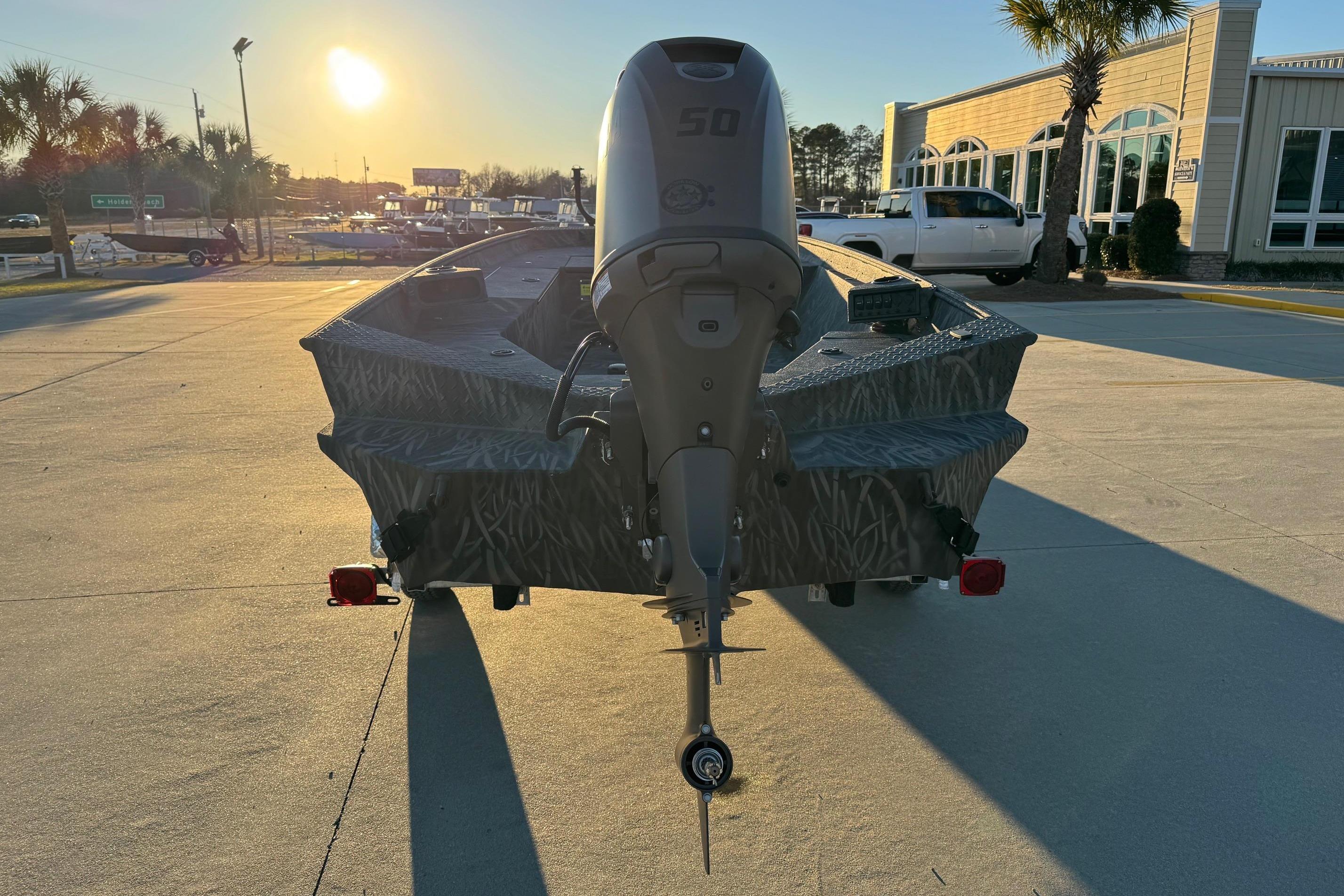 2026 Alweld 1652 Invader boat with motor, parked at sunset.