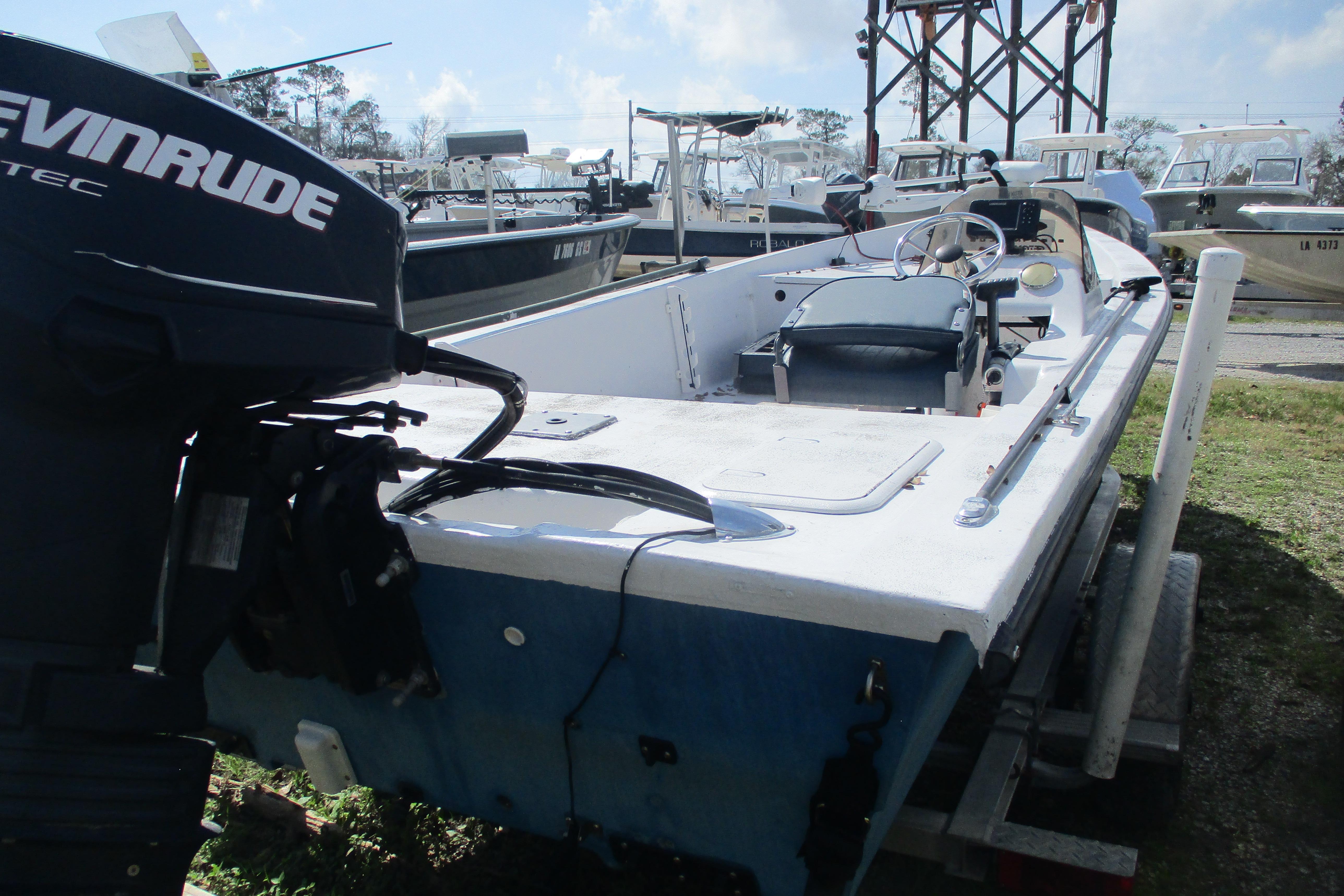2012 Stumpknocker 17 SPORT boat with Evinrude motor, parked on a trailer.