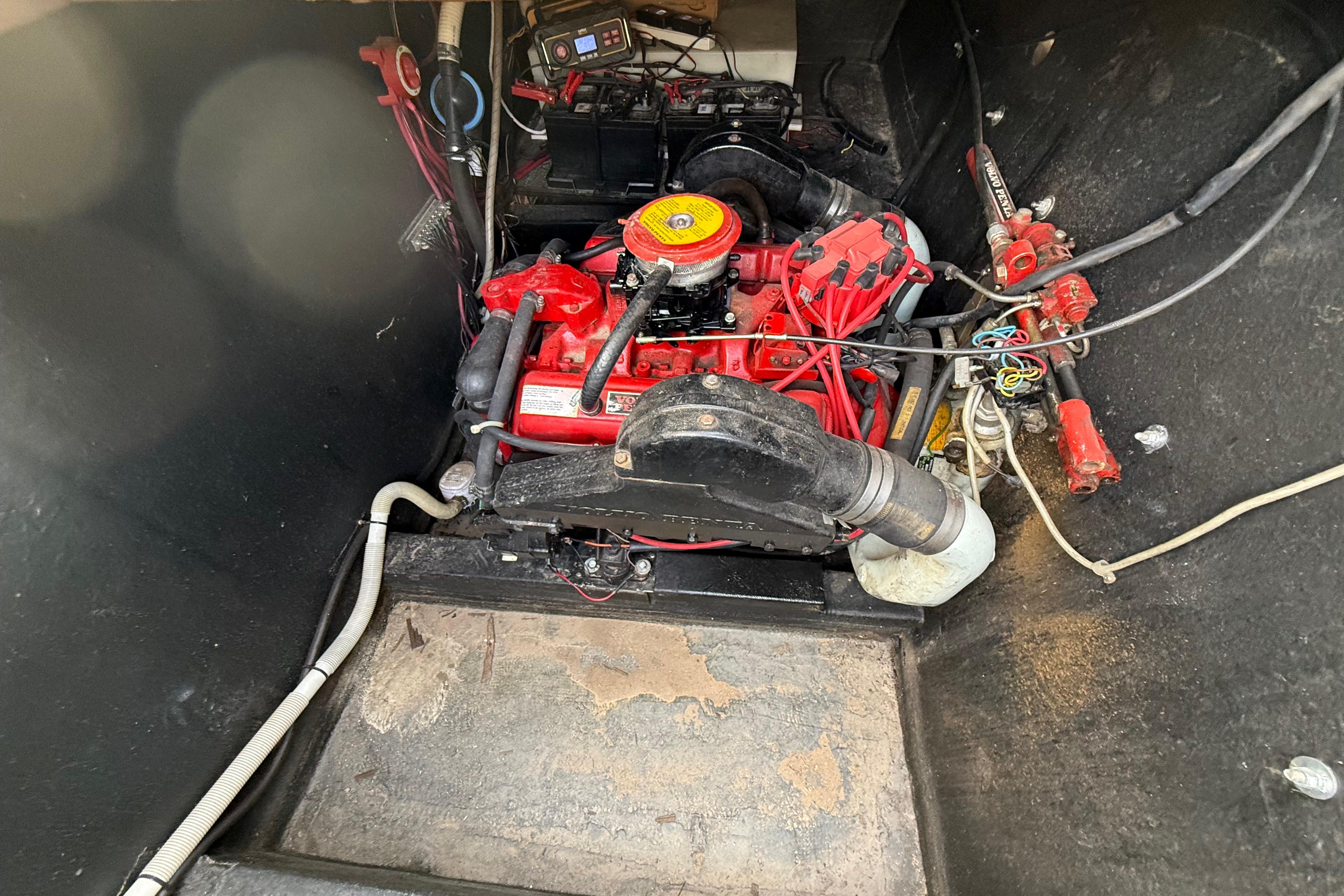 Engine compartment of a 1983 Holiday Mansion 37 Barracuda boat, featuring a red engine.