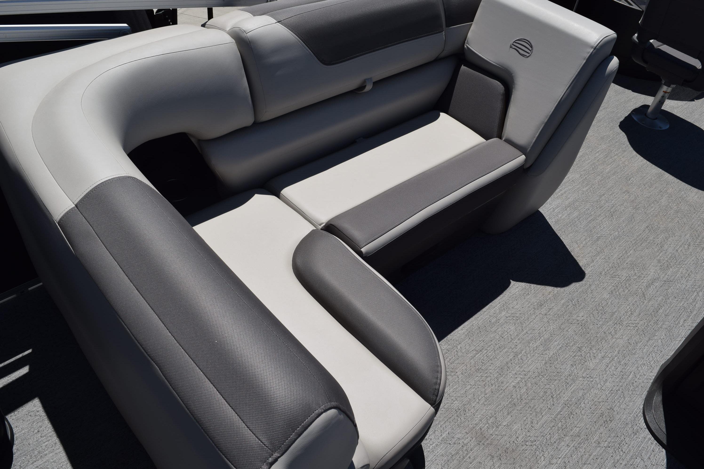 2026 Sun Tracker Fishin' Barge 20 DLX, featuring comfortable gray seating.