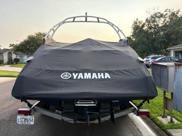 2021 Yamaha AR250 boat with cover parked on trailer.