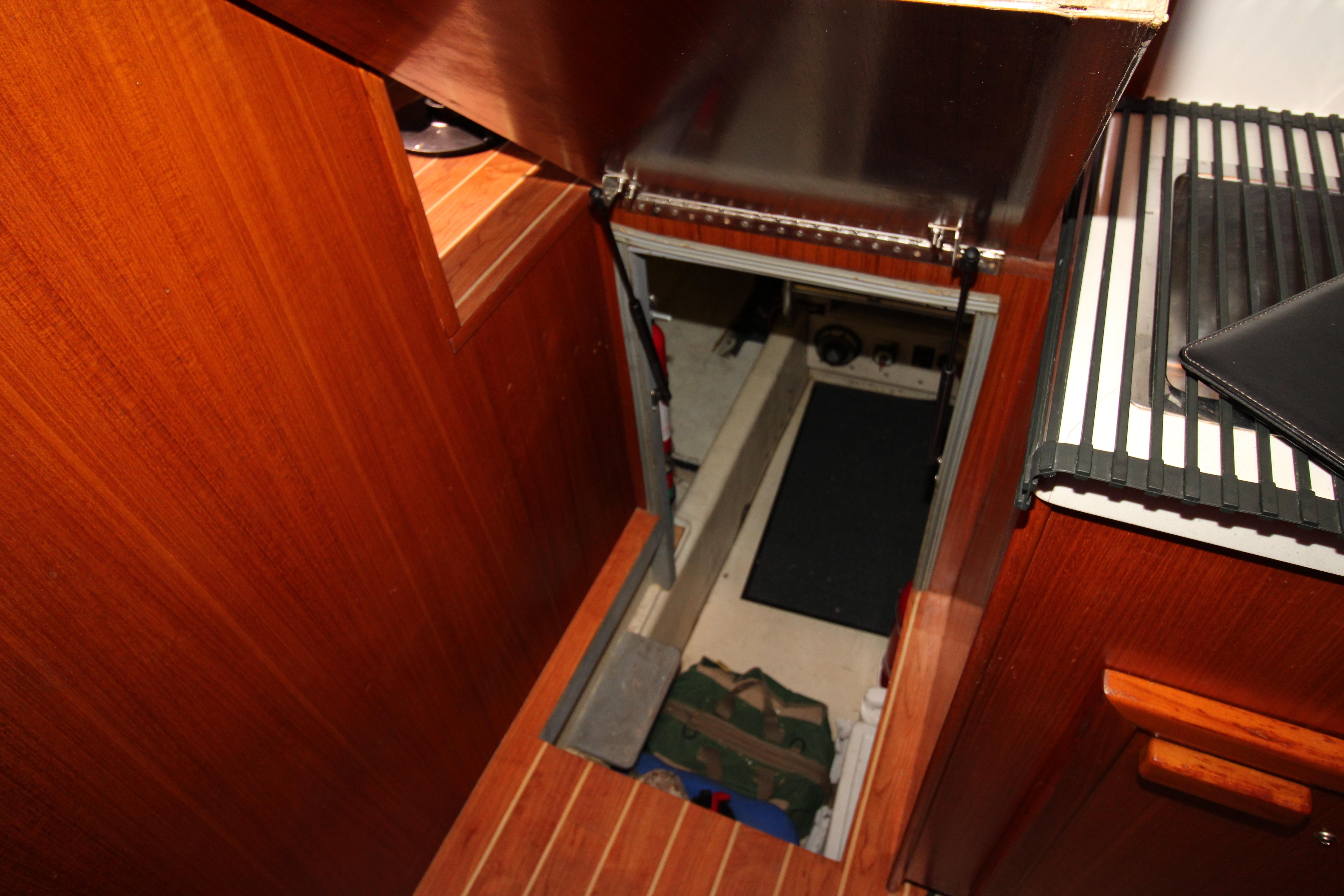 Engine room access on 2000 Ricker 42 Classic yacht with wooden interior.