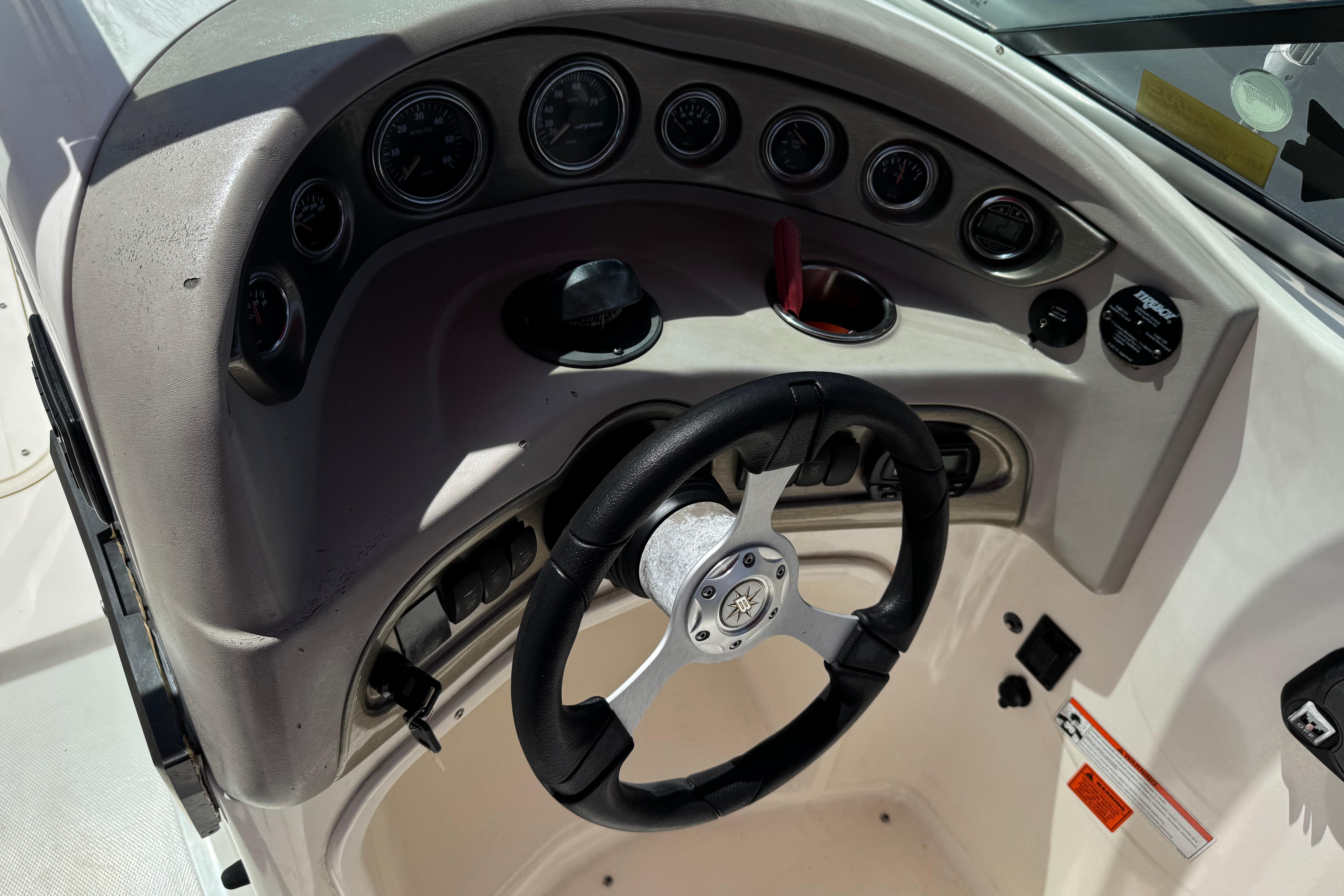 Steering console of a 2010 Bryant 255 boat with gauges and controls.