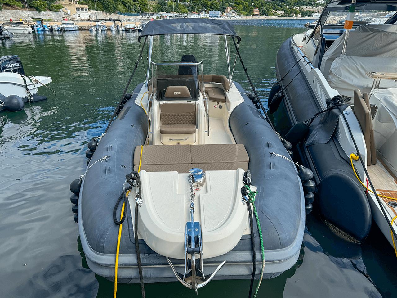 BSC 78 inflatable boat, 2019 model, docked in a marina with scenic background.