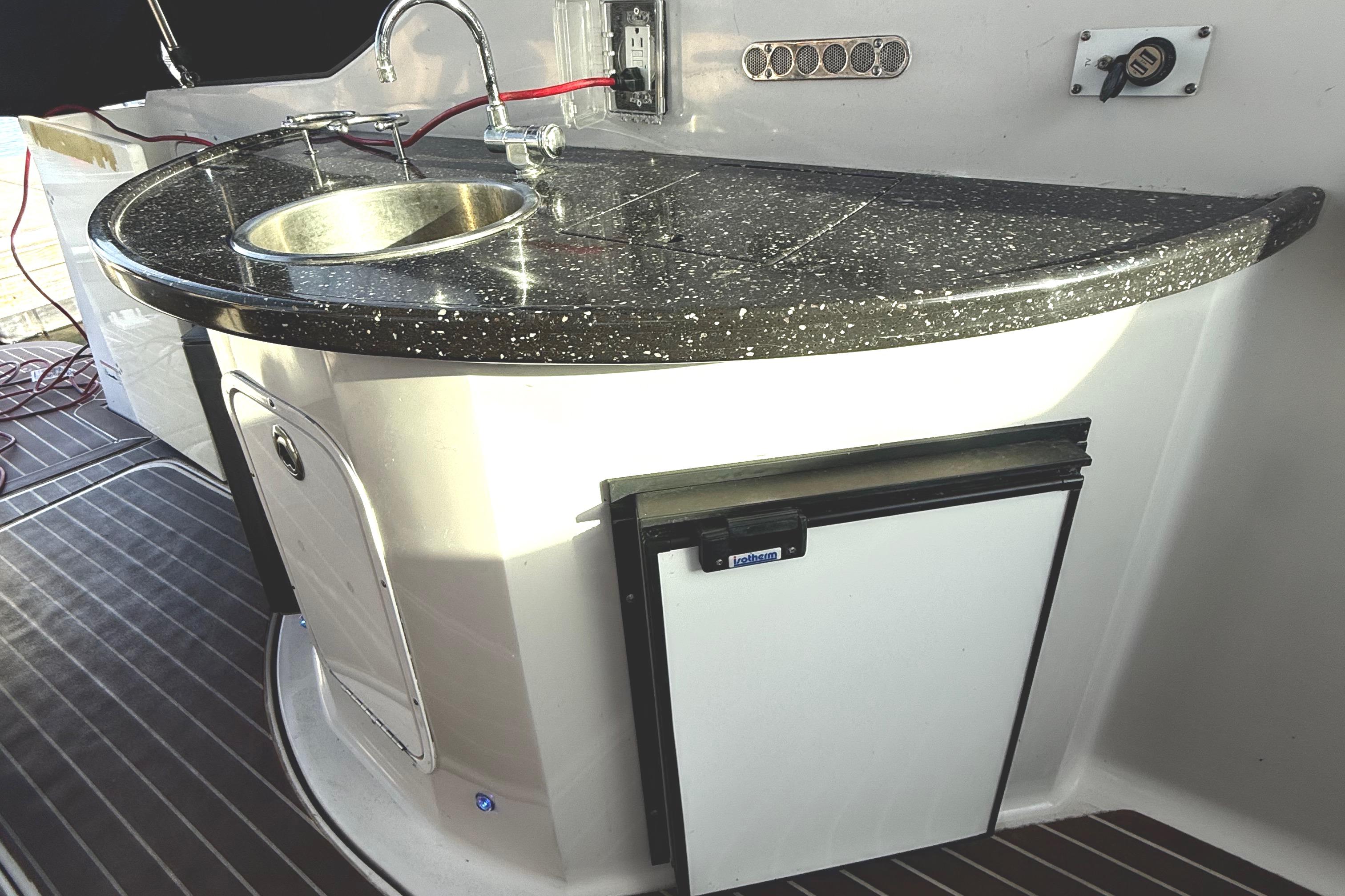 2008 Four Winns 378 Vista boat kitchenette with sink and mini fridge.