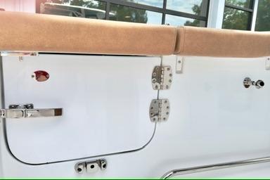 2026 Sea Hunt Ultra 255 SE boat interior detail with beige upholstery and stainless steel fittings.