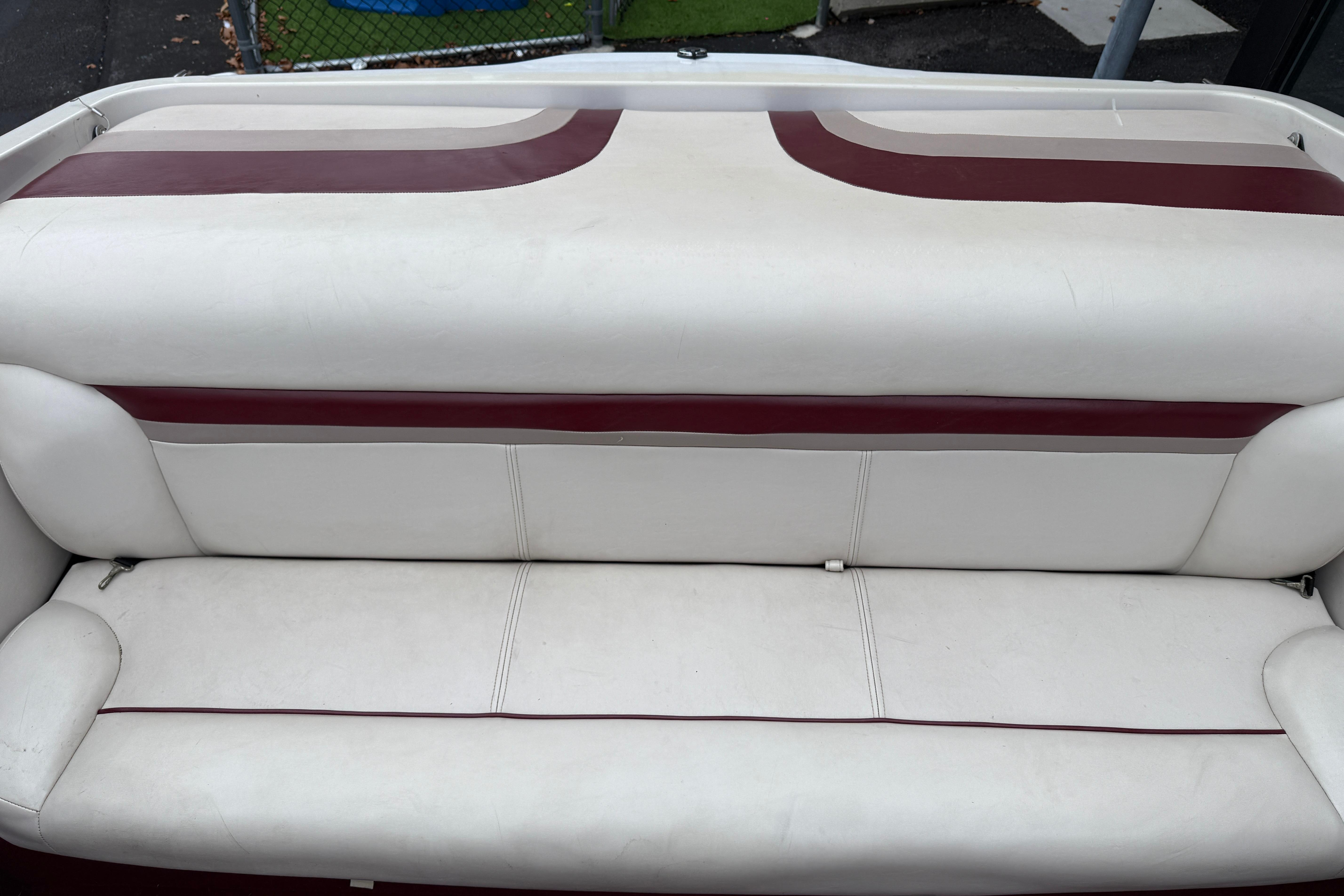 White and maroon boat seat of a 1999 Chaparral 1930 SS.