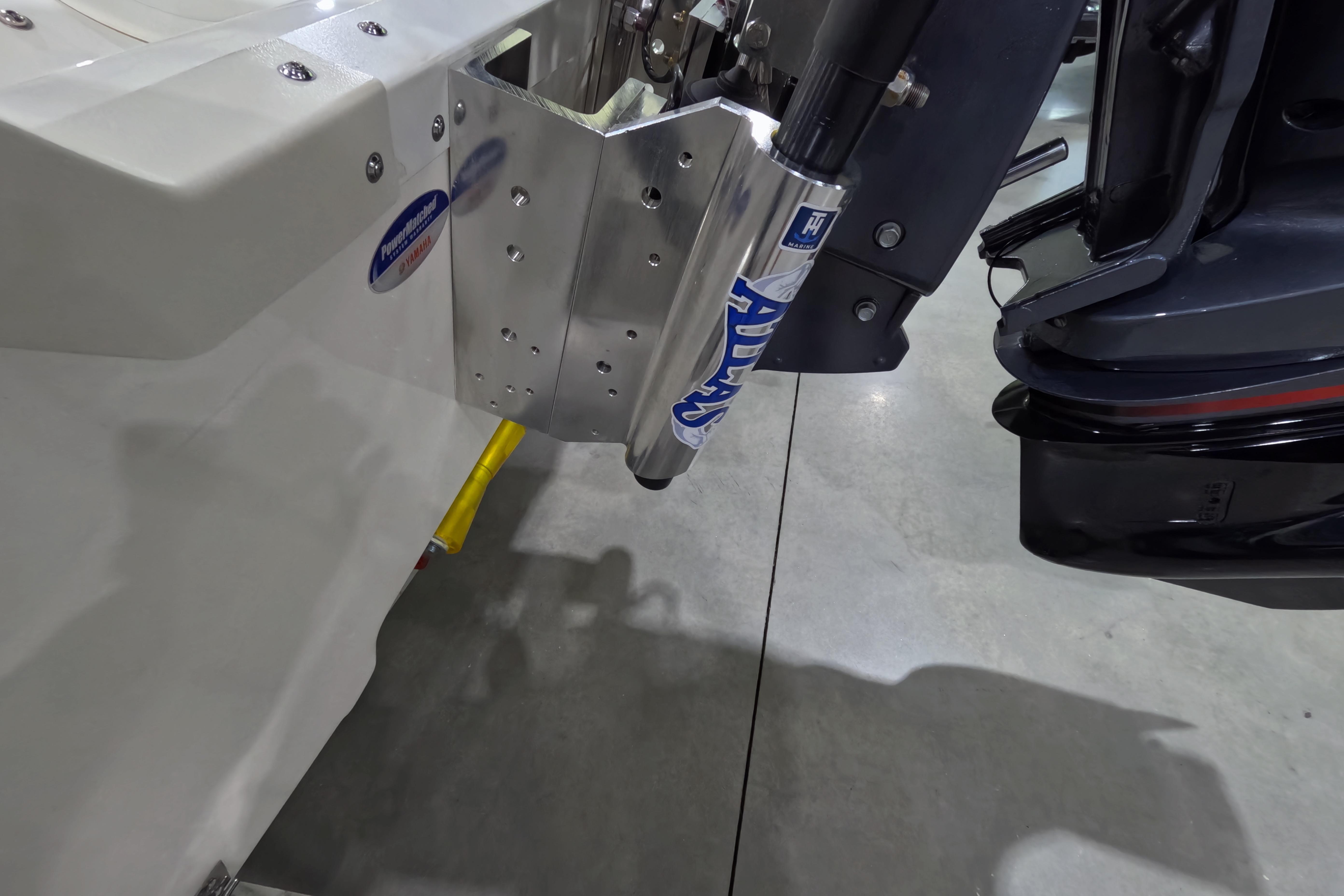 2026 Skeeter SX230 boat motor mount with hydraulic jack plate in a showroom.