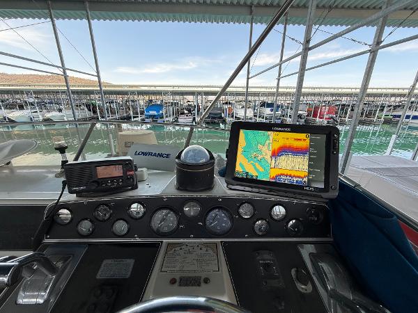 1992 Carver Command Bridge 2828 helm with navigation equipment and marina view.