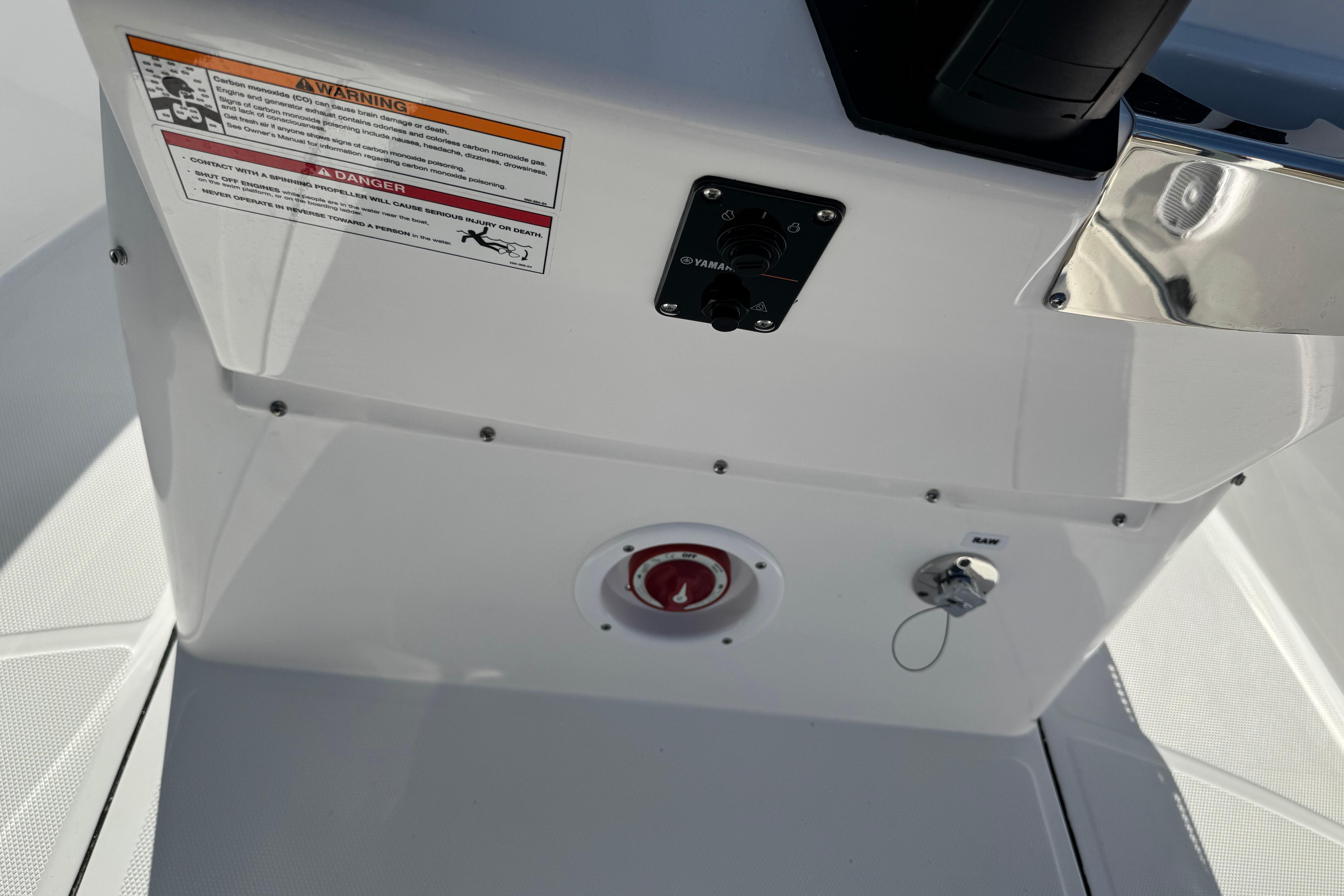 Edgewater 170CC 2026 boat console with warning labels and ignition switch.