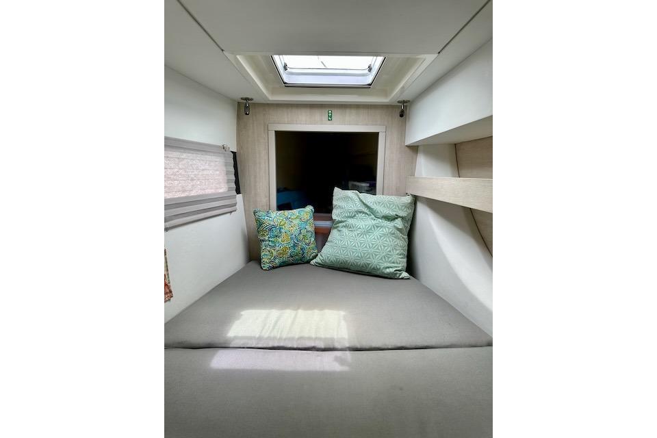 Cozy interior cabin of 2017 Leopard 40 catamaran with cushions and skylight.