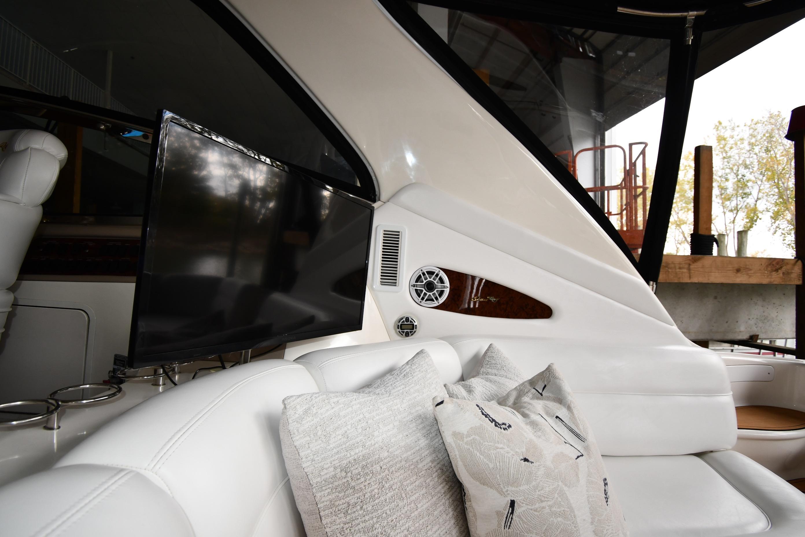 Luxurious interior of 2001 Sea Ray 540 Sundancer yacht with plush seating and TV.