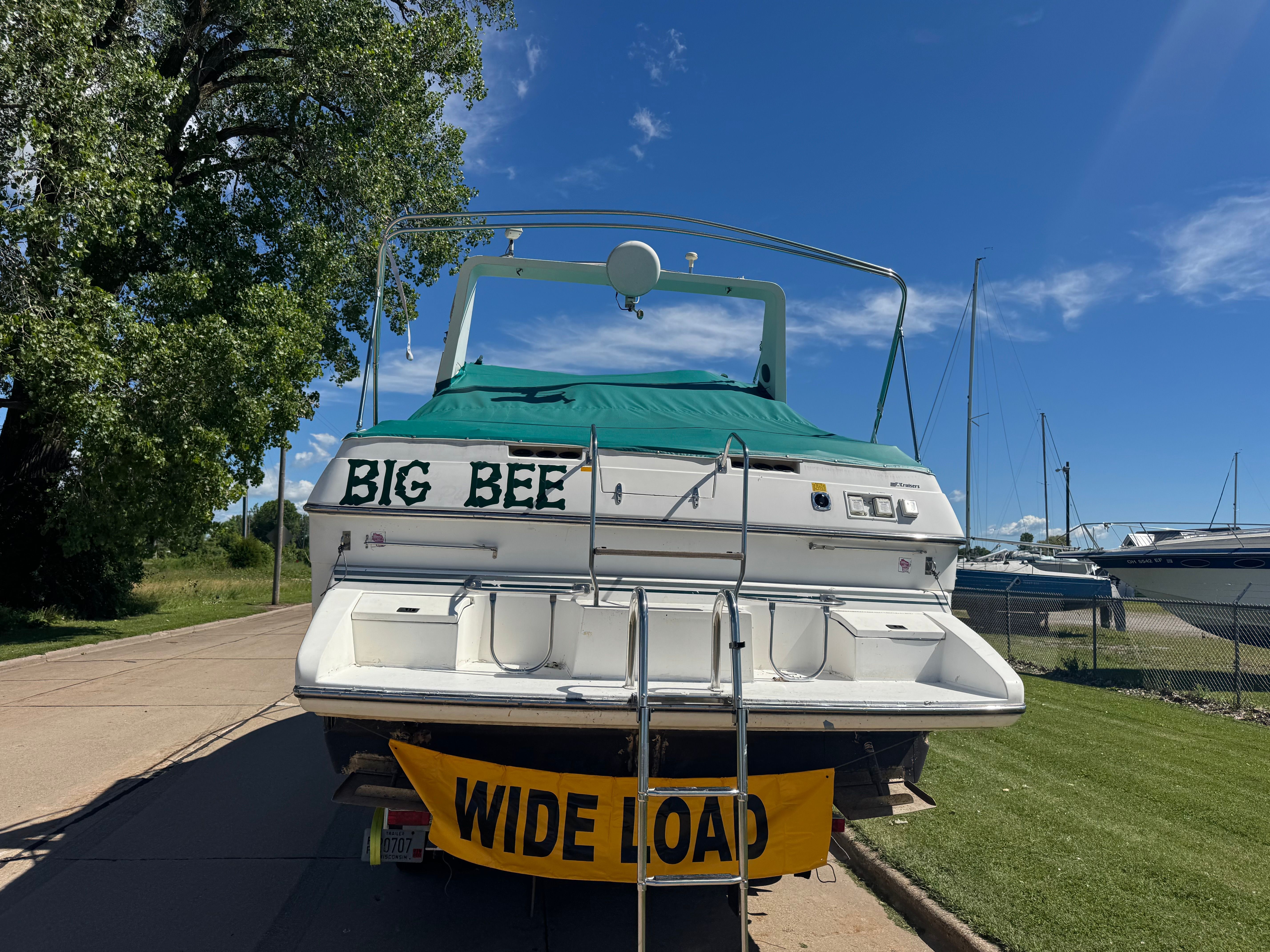 The boat "Big Bee" is a 1992 Cruisers Yachts Esprit 3370 with a "Wide Load" sign.