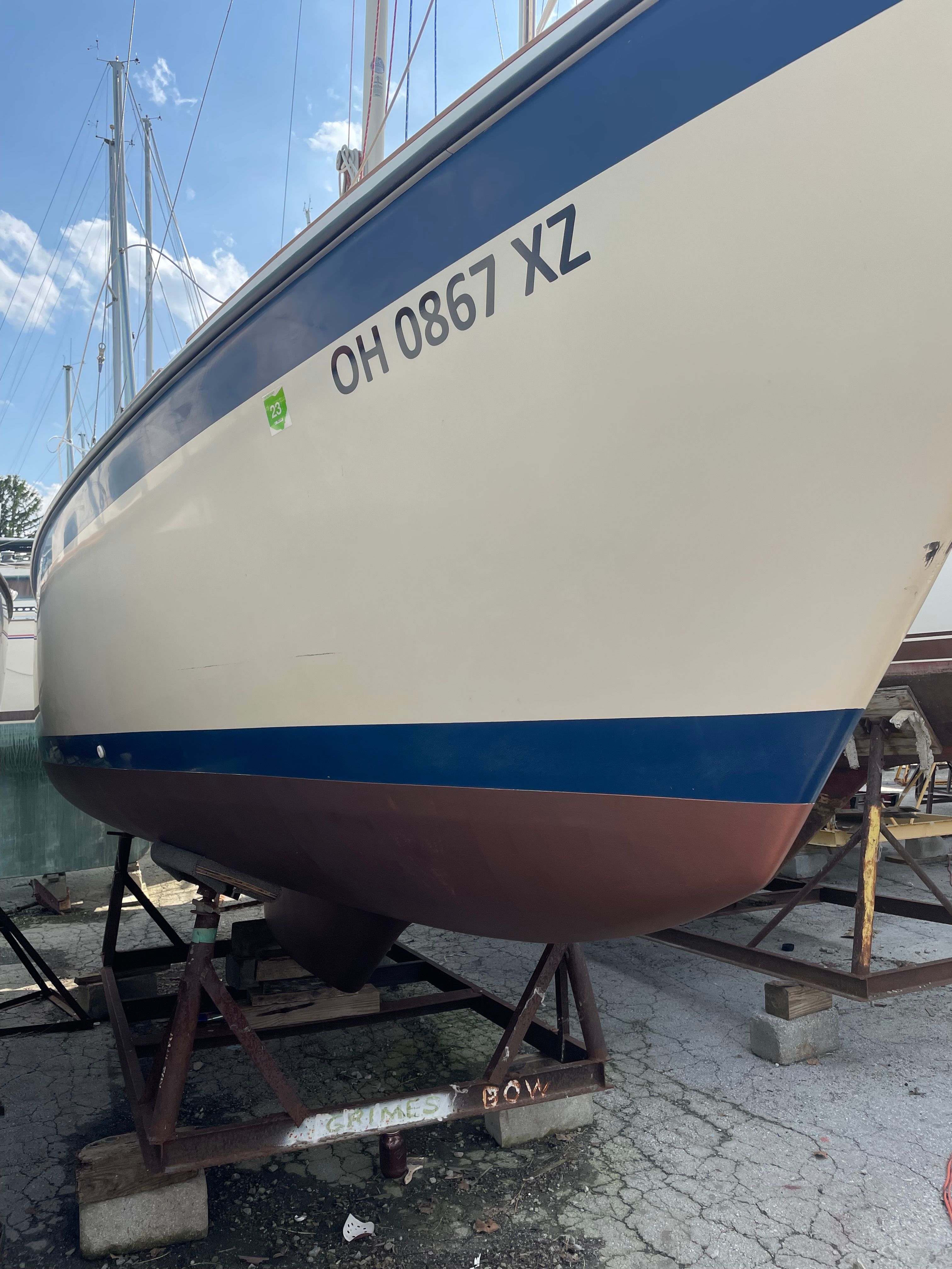 1984 O'Day 25 sailboat on a stand outdoors.