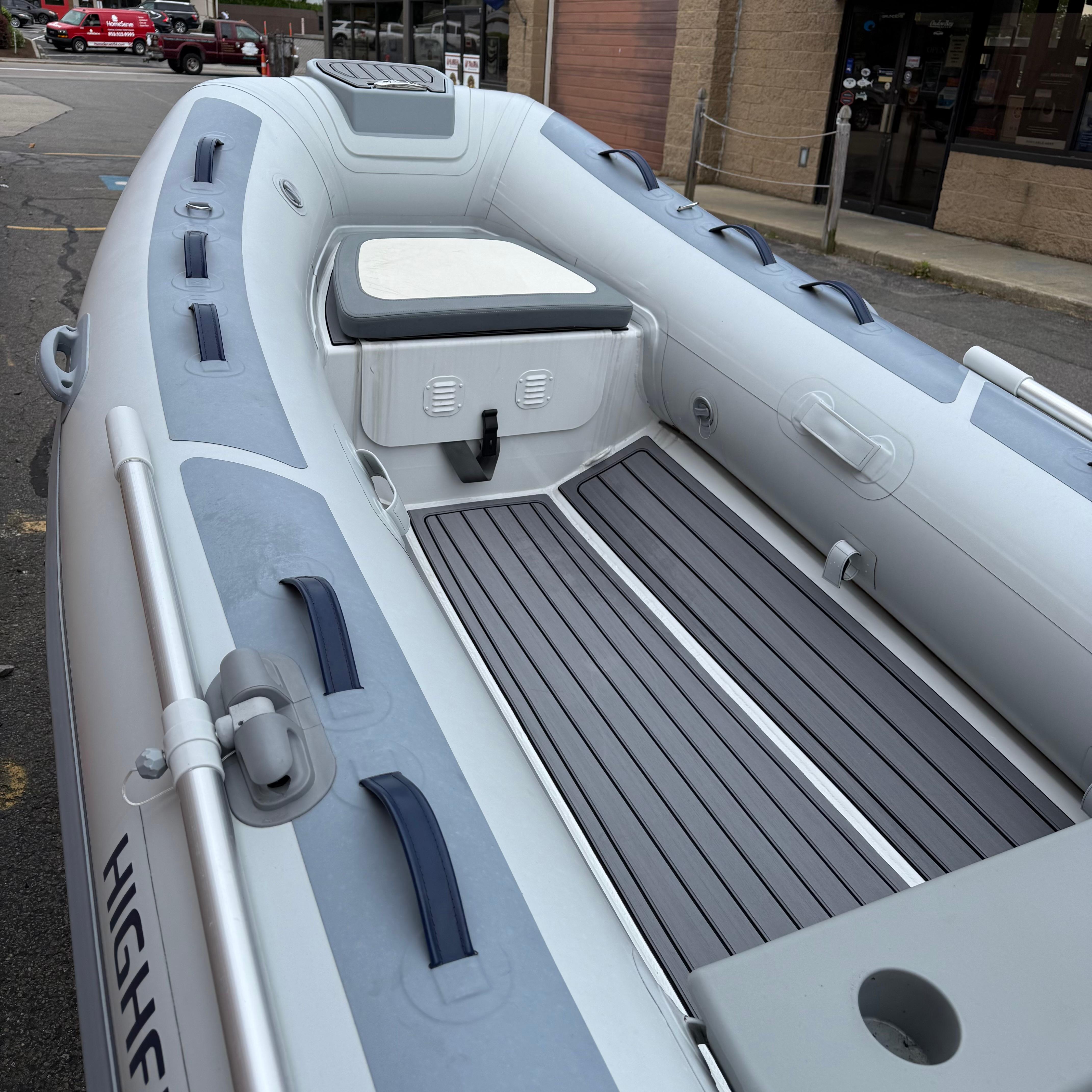 2024 Highfield CL340 inflatable boat with seating and storage, docked outdoors.