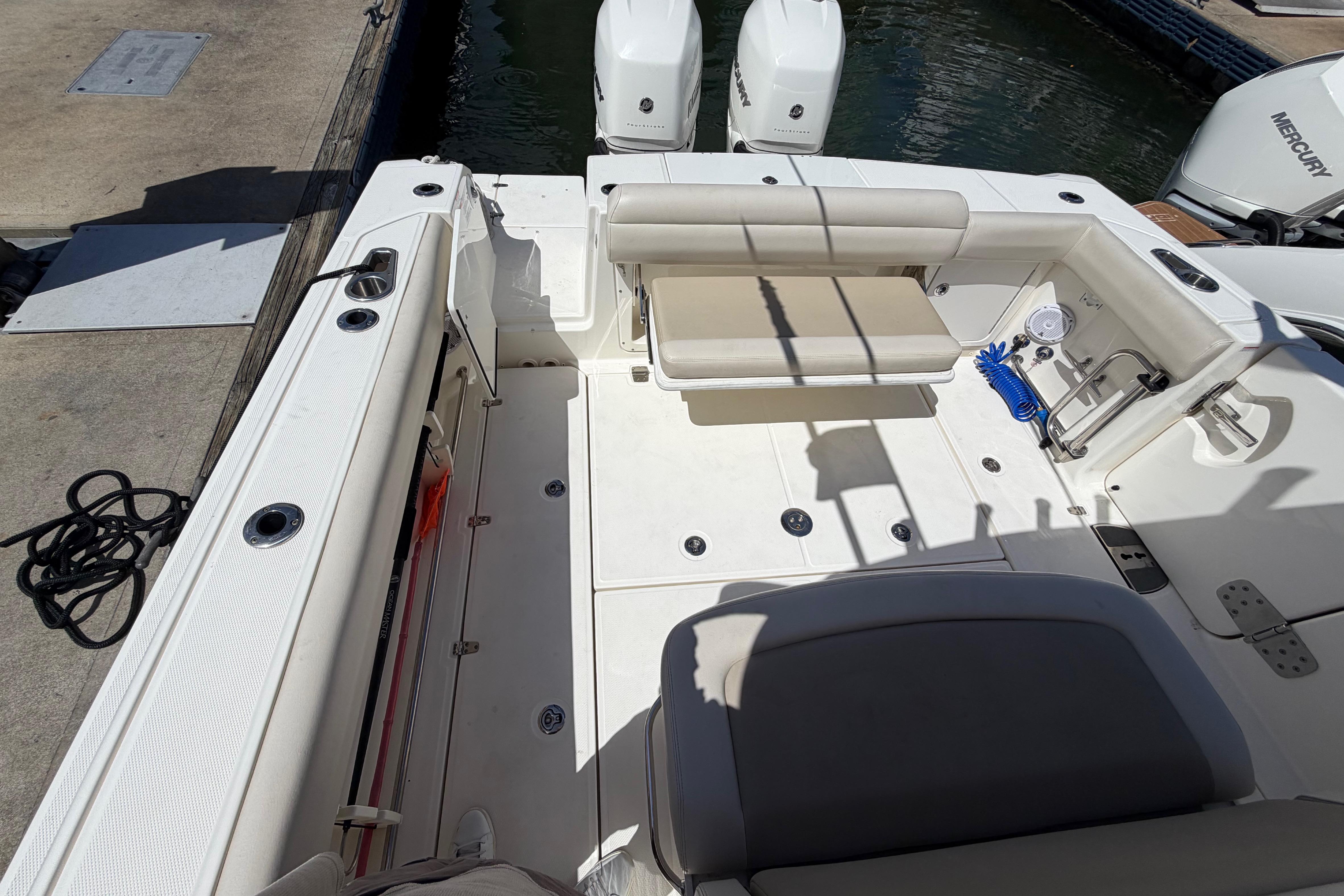 2019 Boston Whaler 330 Outrage boat interior with seating and twin Mercury engines.