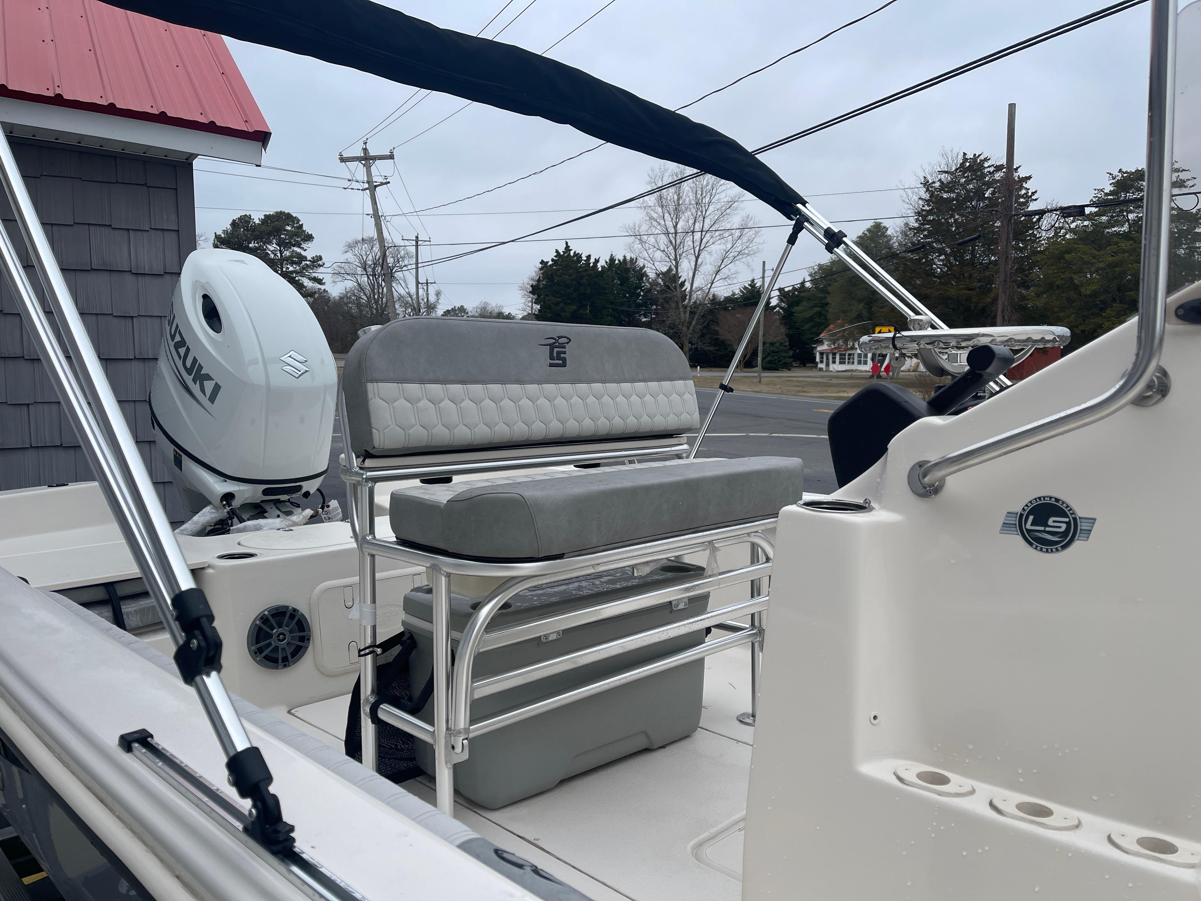 2025 Carolina Skiff 21 LS boat interior with seating and Suzuki outboard motor.