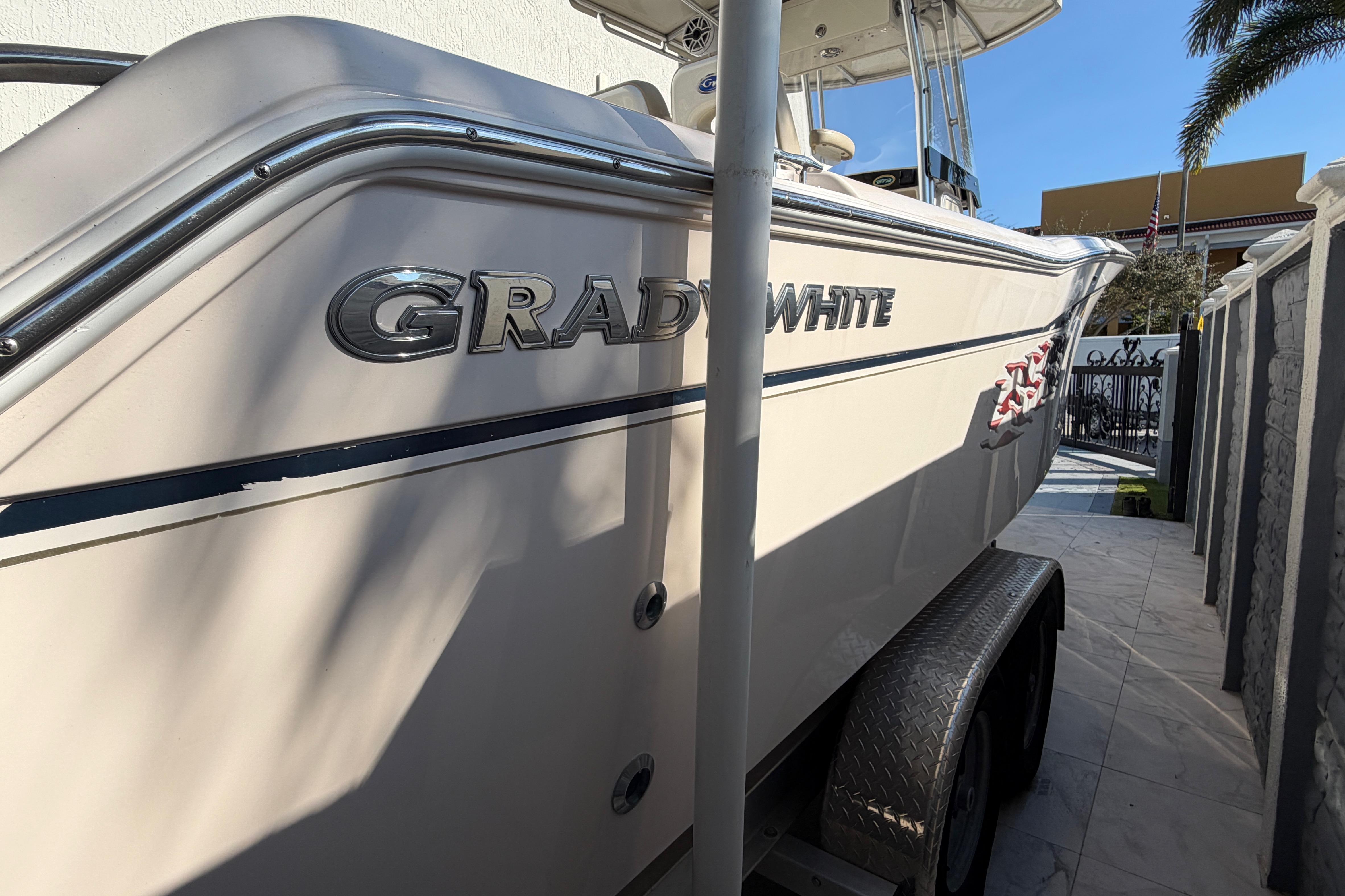 2004 Grady White 273 boat on trailer, side view with logo visible.