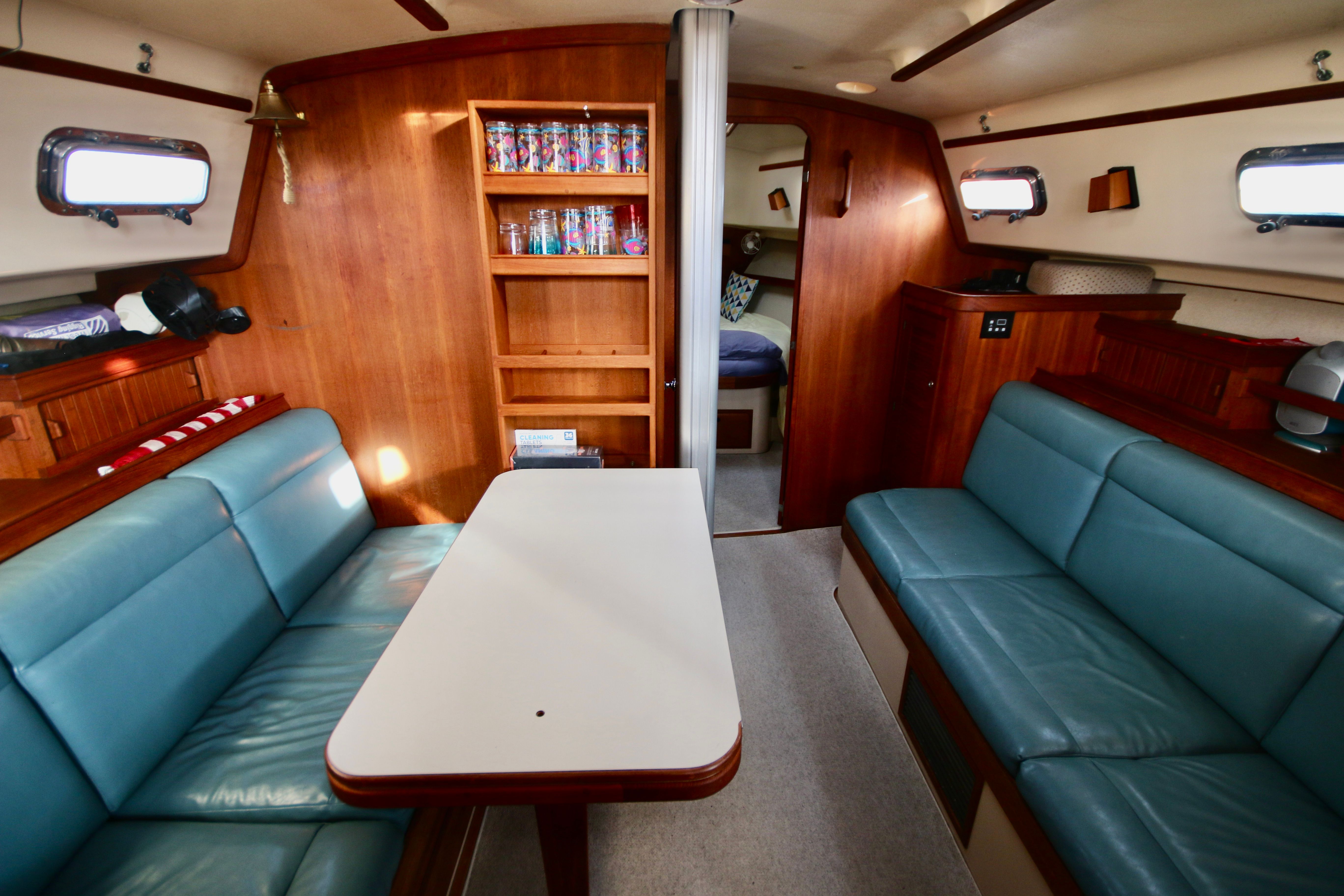 Interior of a 2002 Island Packet 380 yacht with blue seating.