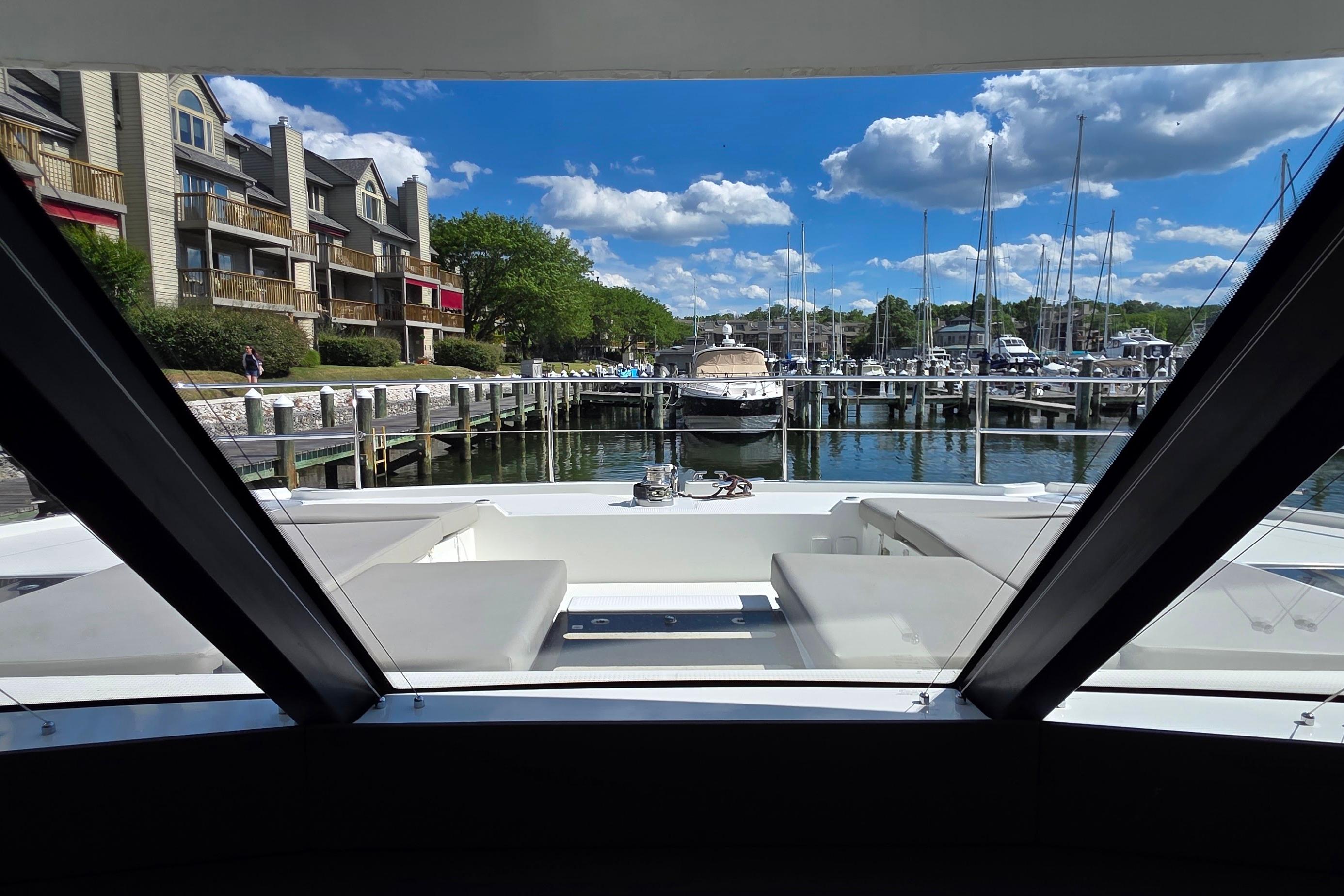 View from 2018 Fountaine Pajot Motor Yacht 44, overlooking marina and waterfront buildings.