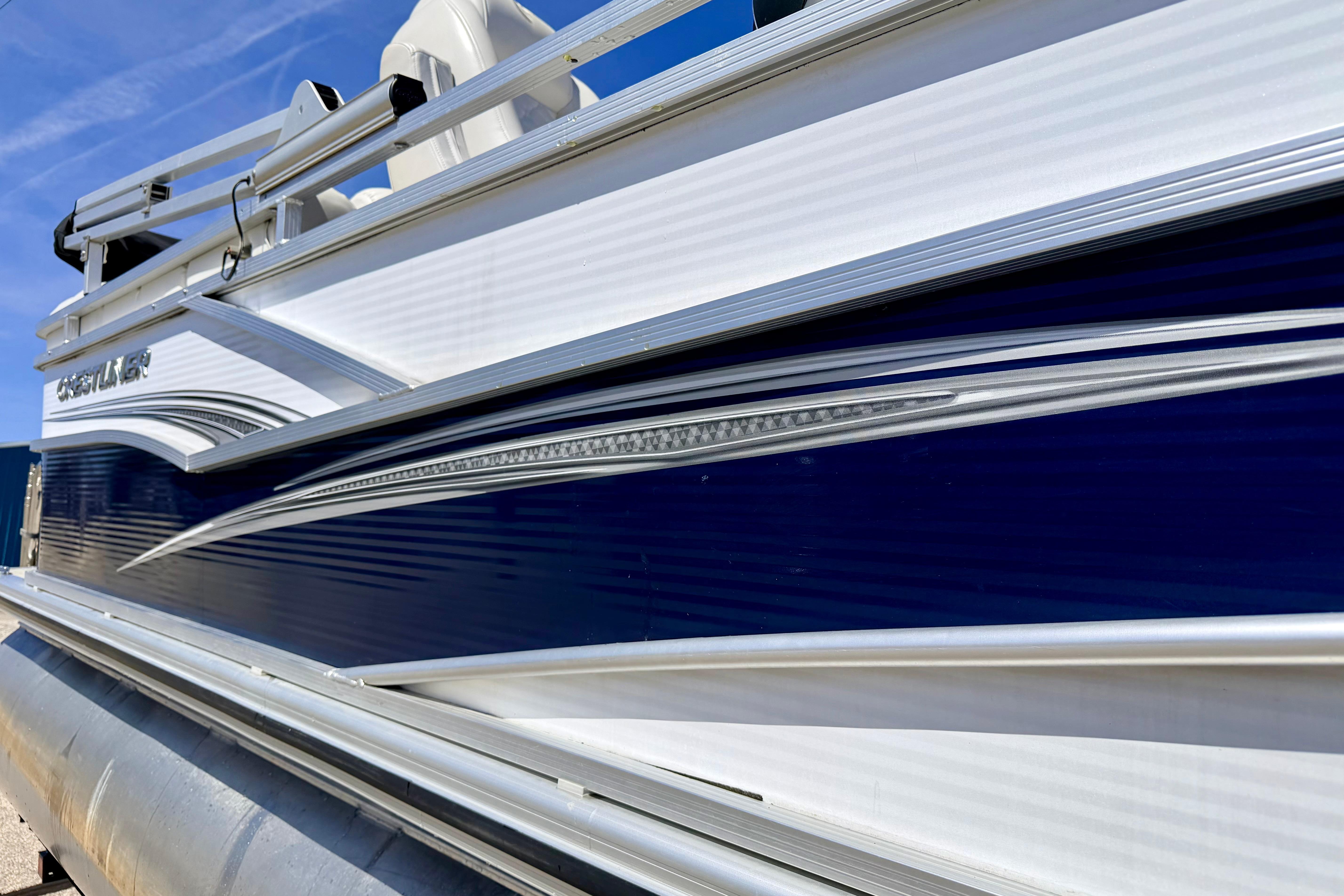 2019 Crestliner 240 Rally DX CW pontoon boat with sleek blue and white design.