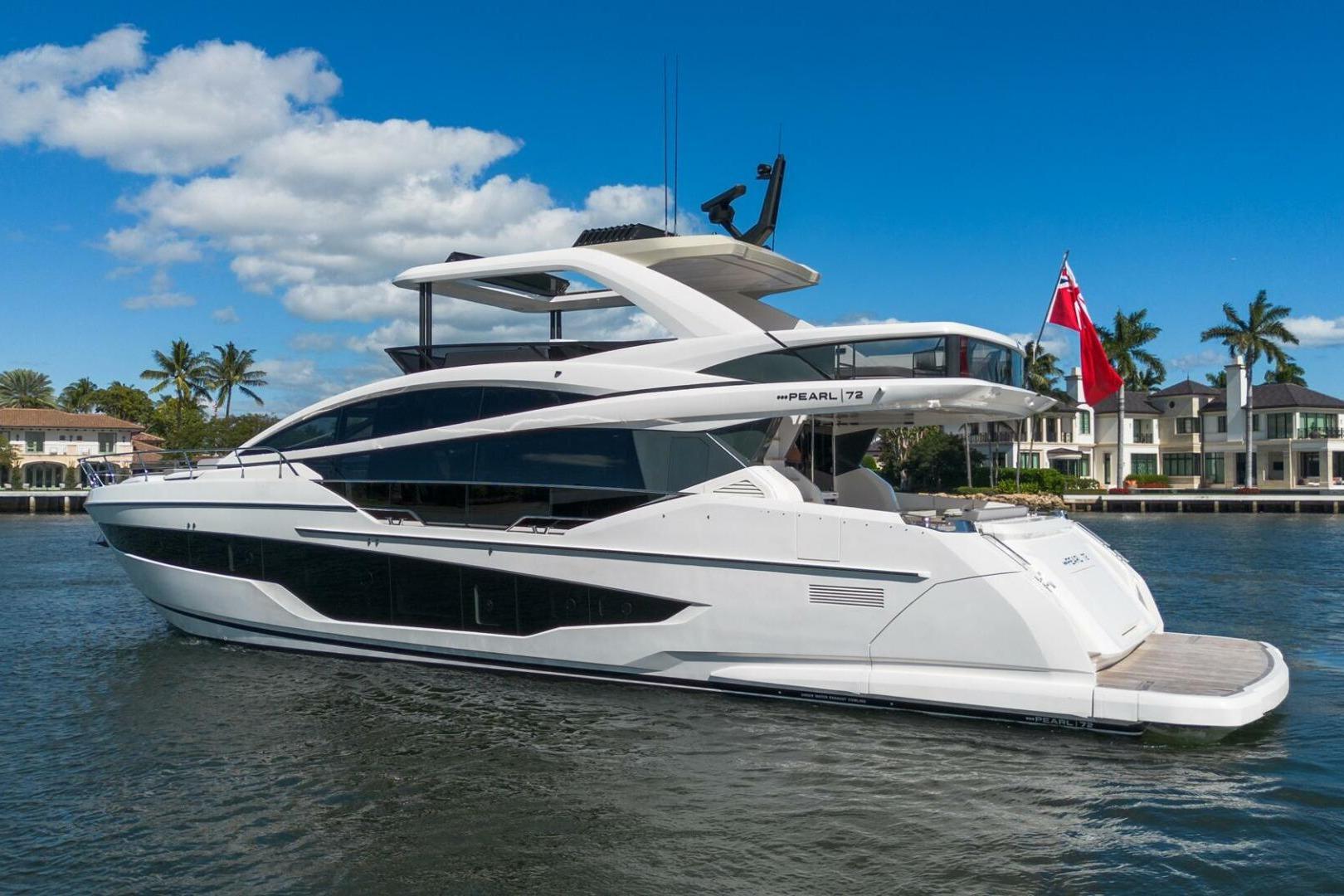 Luxurious 2023 Pearl 72 yacht cruising on a sunny day with palm trees in the background.