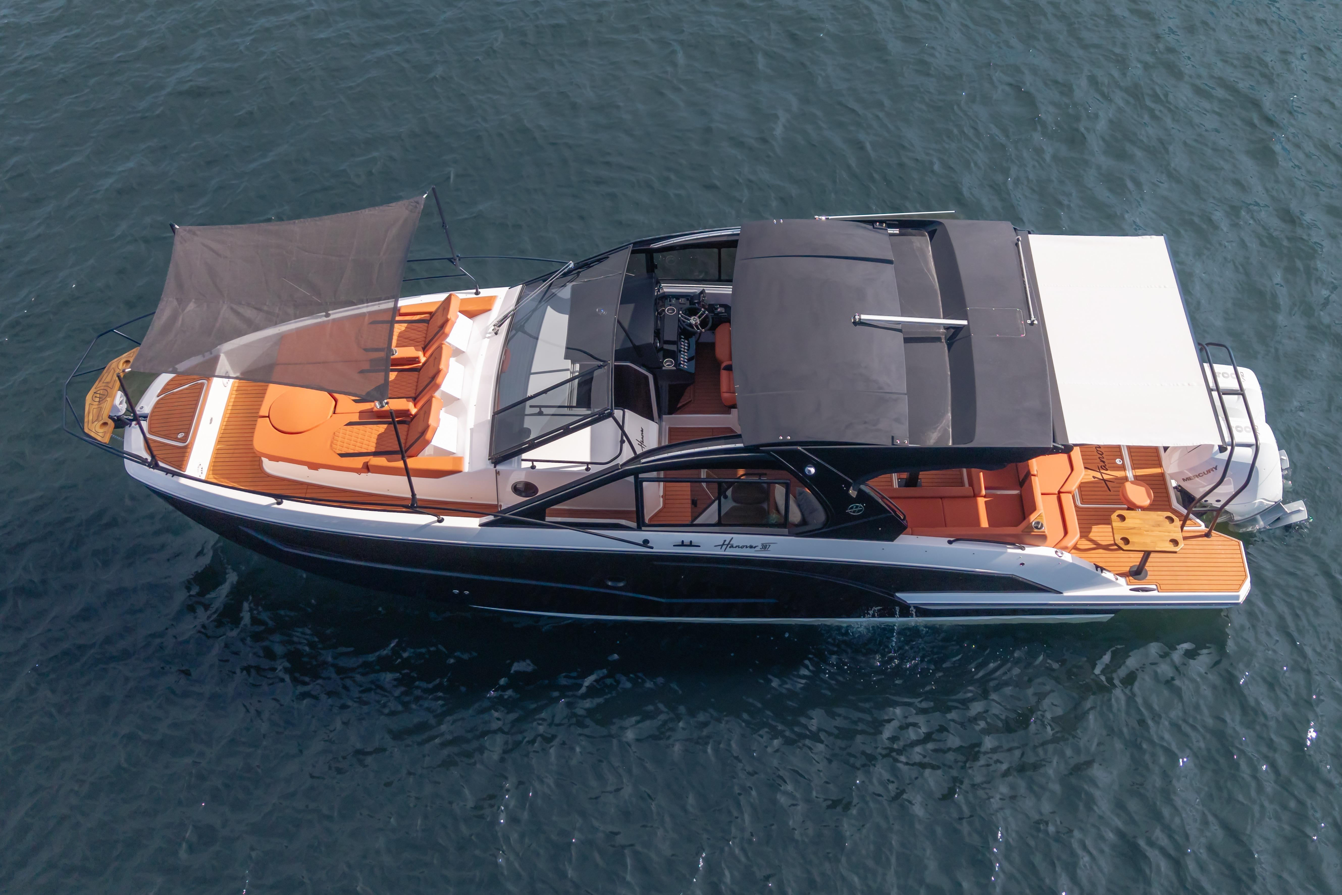 Aerial view of 2026 Hanover 387 luxury boat with sunshade on open water.