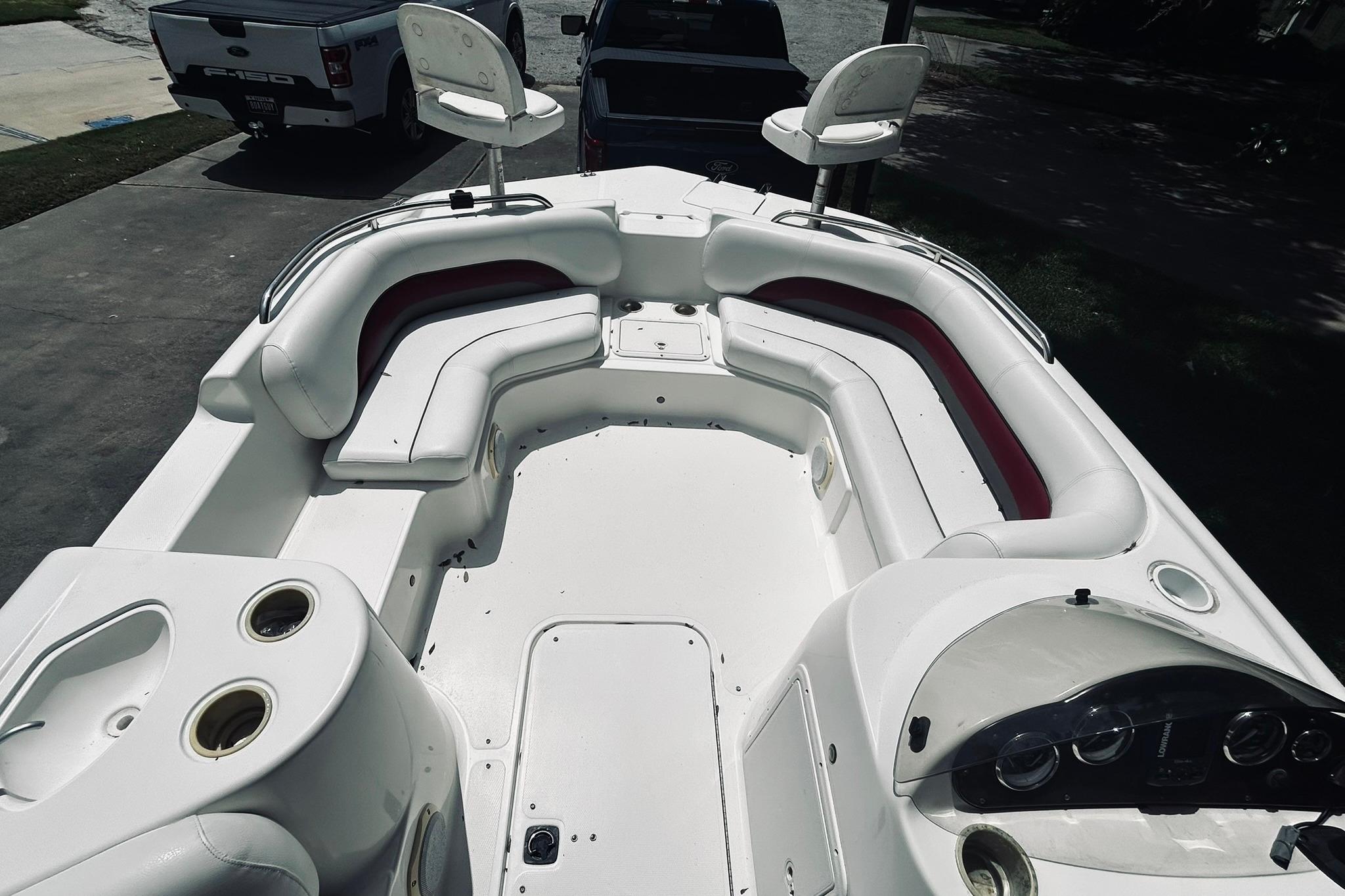 2013 Hurricane SunDeck Sport 201 OB boat with spacious seating and modern dashboard.