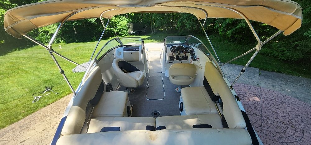 Interior view of a 2007 Sea-Doo sport boat with beige seating and a sun canopy.