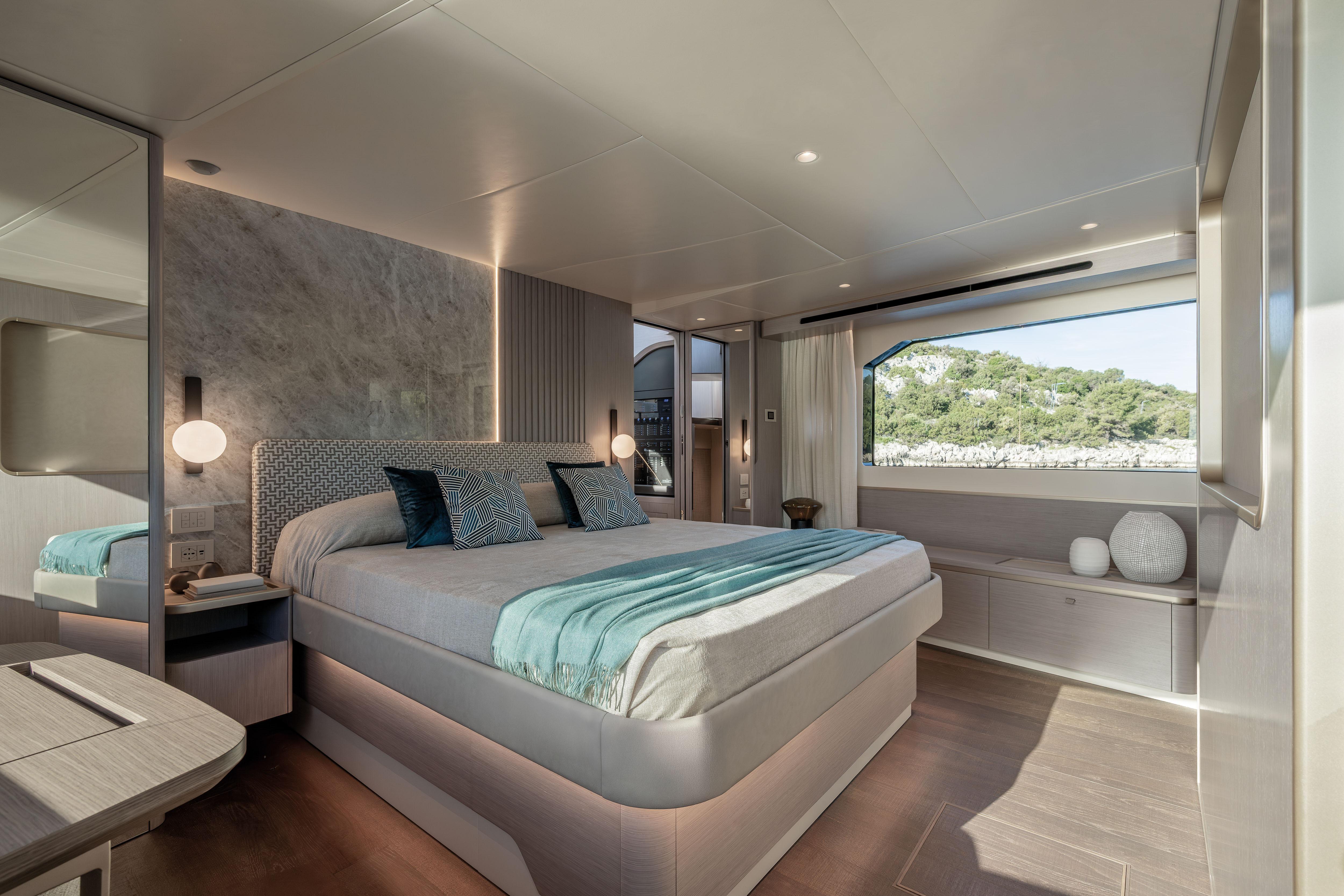 Luxurious bedroom on a yacht with a large window and stylish decor.