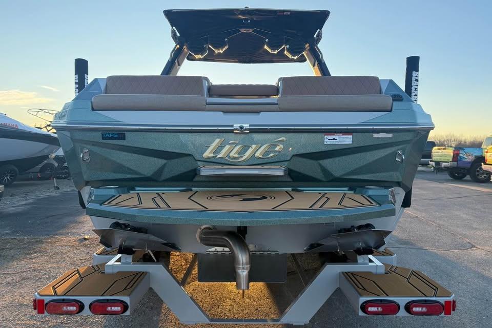 2026 Tigé Z3 boat rear view with swim platform and sunset background.