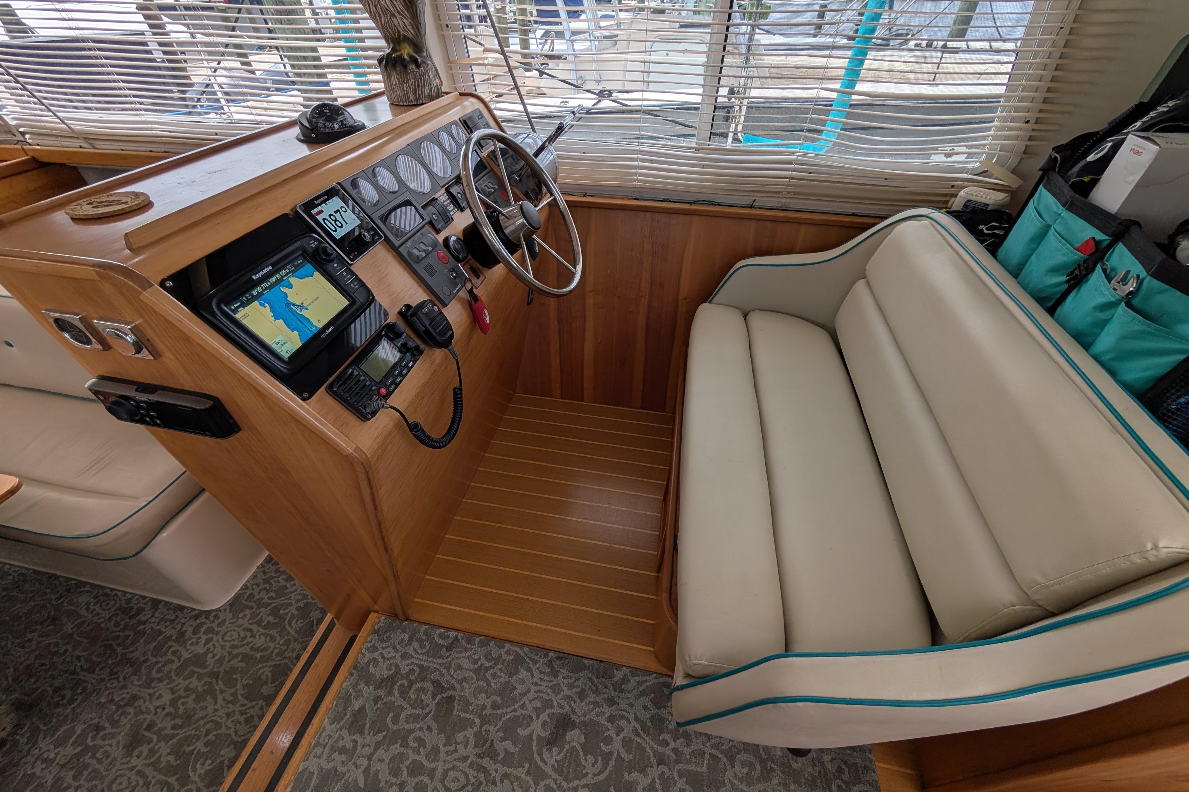2004 PDQ 34 Powercat helm with navigation equipment and comfortable seating.