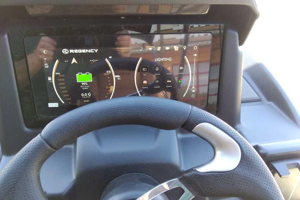 Steering wheel and digital dashboard of 2026 Regency 230 DL boat.