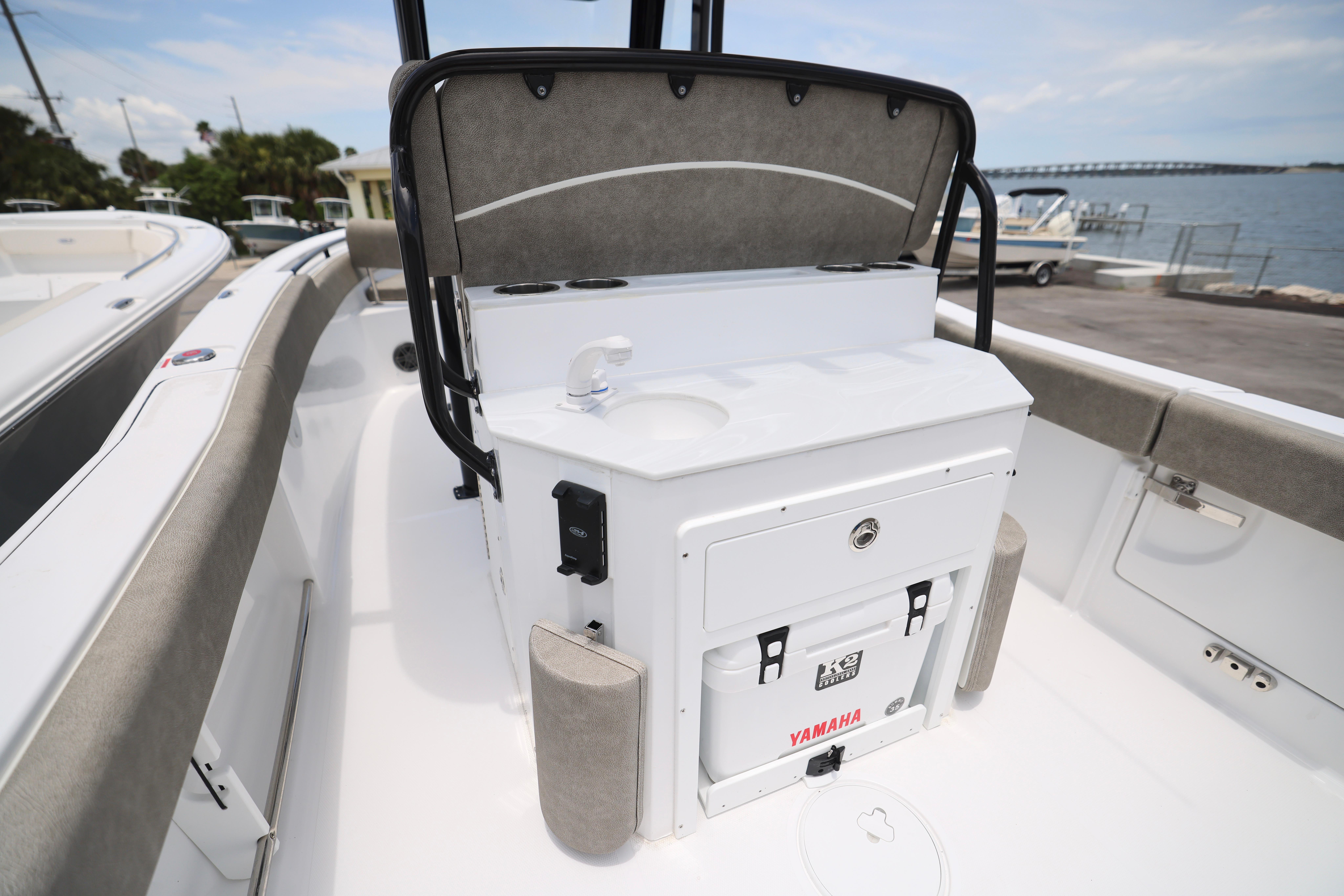 2026 Sea Hunt Ultra 245 SE boat interior with seating and storage, dockside view.