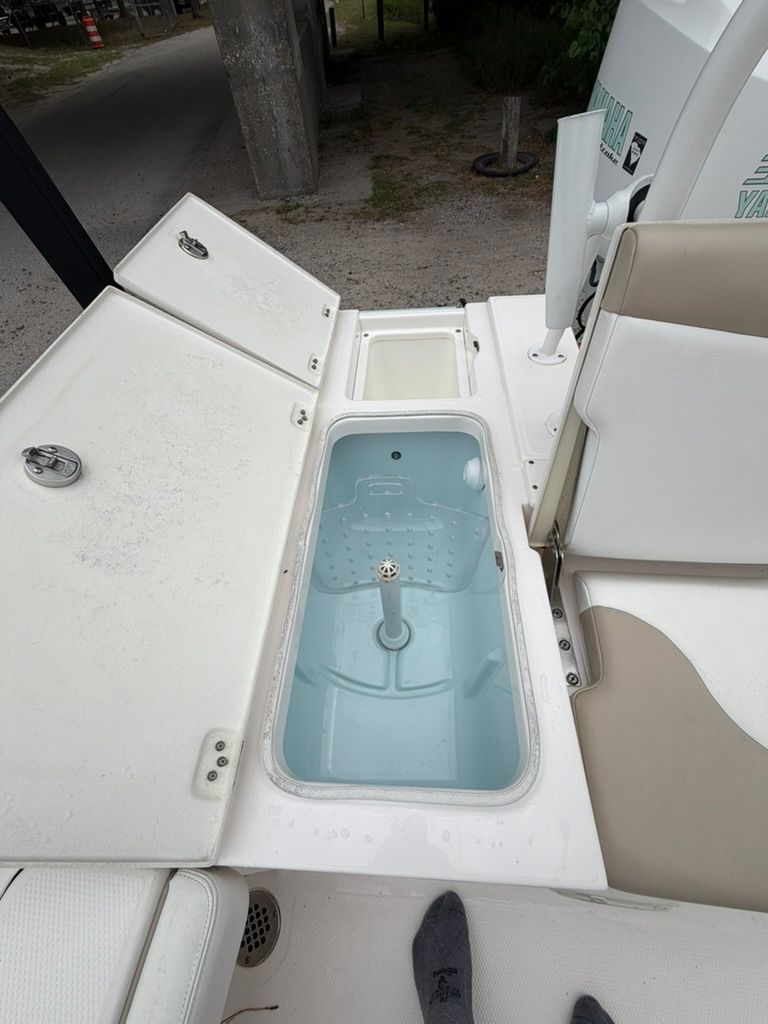 2018 Robalo 246 Cayman SD with open storage and seating area.